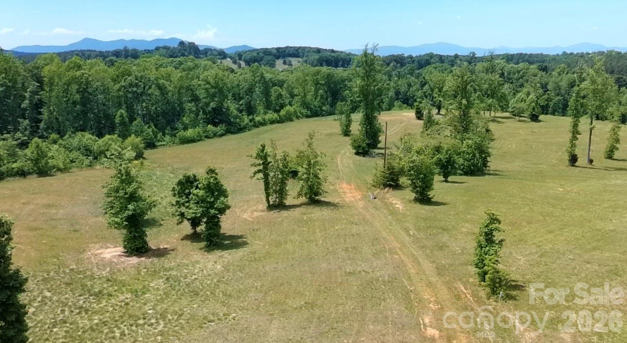 Escape to the ultimate 30-acre equestrian sanctuary and private mountain estate at 473 McEntire Rd, Tryon, NC. Perfectly suited for a premier private horse farm, expansive training facility, or multi-generational family compound, this rare parcel offers completely unrestricted acreage with absolutely NO HOA, giving you total architectural freedom in Western North Carolina’s coveted 'Thermal Belt' microclimate, known for its remarkably mild winters and cool mountain breezes.Located in scenic Polk County just 15 minutes from the world-class Tryon International Equestrian Center (TIEC), this property perfectly bridges the gap between a secluded luxury lifestyle and elite equestrian access. For out-of-state buyers looking to build, this blank canvas is uniquely development-ready: multiple level, prime build sites have been identified to perfectly position a main estate, guest cottages, or custom horse barns to maximize privacy and panoramic foothill views.