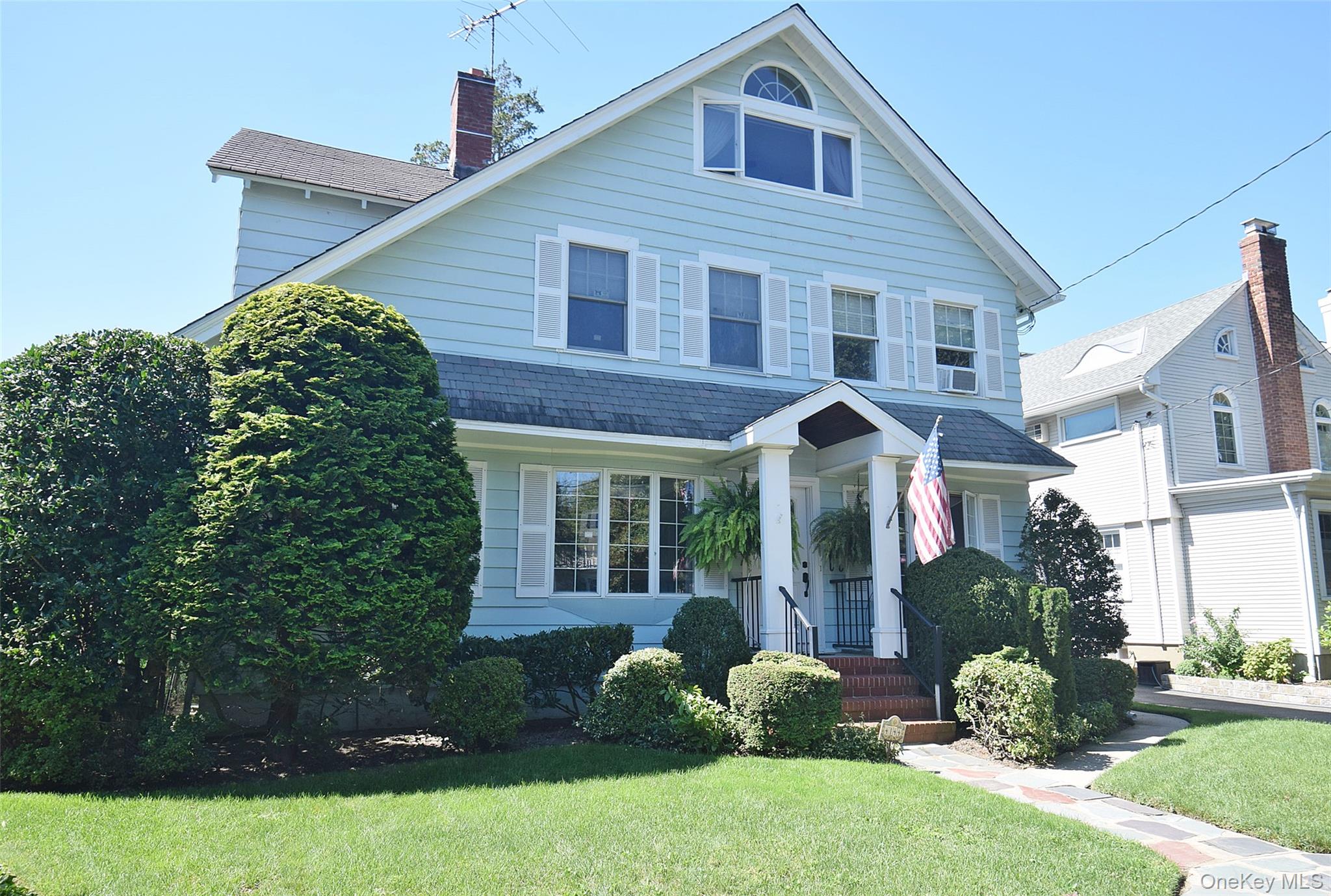 Situated on quiet corner in the Westmoreland Area of Little Neck is this charming and spacious Colonial renovated for modern comfort and gracious living.  This home features a spacious living room with fireplace , a bright and open formal dining room, leading to a renovated kitchen and glass enclosed sitting room, perfect for morning coffee, bird watching, or a quiet chat.  The first level also has a den/TV room anda half bath.  The second level of this home features a large bedroom with walk in closet, two additional bedrooms and a 9x12 modern bathroom with steam shower.  The third level of this colonial is now theprimary bedroom with full bath.  The property is perfect for entertaining, both inside and out.  This home is one block to PS94, the David Porter Ellementary School, designated a 2026 National Gold Star School, and within walking distance to MS 67.  High School is Cardozo.  Five minutes away is the LIRR station with service to both Penn and Grand Central stations. The convenience of a small city town,  the best schools, easy access to Manhattan, reasonable property tax, and suburban style living make Little Neck a wonderful place to live!