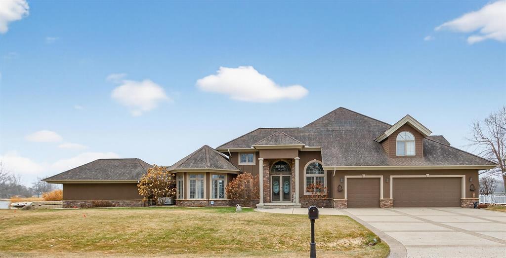 Commanding 172GÇ¦ of pristine shoreline on the coveted Irish Mist peninsula at private all sports Loch Erin, this fully custom masterpiece offers front-row sunset views from nearly every room. Step inside to a soaring great room with tongue-and-groove vaulted ceilings & dramatic exposed beams. Key Highlights - Brand new gourmet kitchen with Cambria Quartzite countertops & seamless backsplash: dual islands, walk-in pantry, Bosch black-stainless appliances updated in 2022; Main-floor primary retreat: double-sided fireplace, spa bath, private patio to the water; Loft-style upper landing with 3 spacious bedrooms, 2 en-suite baths; East-wing den--ideal media lounge or guest suite; 3.5-car attached garage PLUS separate single-stall lakeside garage & 2600 sq ft lighted crawl space with concrete floor--exceptional storage for lake toys & seasonal gear. Private concrete boat launch; Adjacent Park space for unmatched privacy, views, and green buffer. Start living the lake life you have imagined!