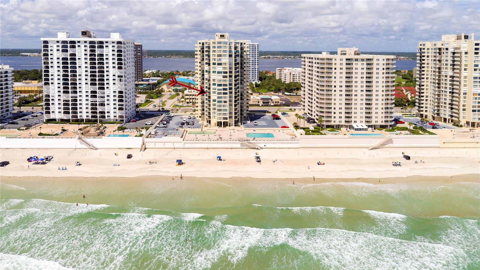 Located on the 7th floor with the much-desired southeast direct ocean views, this condo is ideally located for convenience and the best of oceanfront living. Enjoy the ocean breezes from the direct ocean-front balcony, watch a shuttle launch or spy on beachgoers below.  Light and bright, the big windows maximize the joy of sunrises and ocean and river views.  The kitchen, with corian counters and white cabinets, is open to the dining room. The two bedrooms are generous, with an ensuite primary bedroom and a second bath with easy access for guests and the second bedroom.  Convenient! Just one block to the Publix Shopping Center and Walgreens, across from an executive golf course, and Daytona Beach Shores Community Center with lots of available activities. Oceans Five is undergoing a multi year renovation including new hurricane glass in common areas, lobby updates, elevator updates, seawall and beach access updates, pool deck updates and life safety improvements to prepare this property for many years to come. On site management provides another level of security for full and part time residents. Electric blinds in the living and primary bedroom. Electric roll down shutters on all but the south facing window. This condo offers a perfect combination of location and ocean front living at an affordable price!