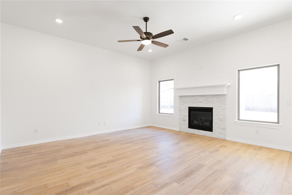 This Dane floor plan features 1,830 Sqft of total living space, which includes 1,700 Sqft of indoor space and 130 Sq Ft of outdoor living. This spacious home offers 4 bedrooms, 2 full baths, 2 covered patios, a utility room, a mudbench for additional storage, and a 2-car garage with an in-ground storm shelter installed. The sizeable living room welcomes high ceilings with a ceiling fan, a center gas fireplace with our stacked stone surround detail, large windows, Cat6 wiring, and wood-look tile. The kitchen supports custom-built cabinets to the ceiling, stunning pendant lighting, 3 CM countertops, a center island, a large corner pantry, modern tile backsplash, and stainless-steel appliances. The primary suite has a sloped ceiling detail with a ceiling fan, our cozy carpet finish, and windows. The attached bath features a dual sink vanity with framed mirrors, 3 CM countertops, a free-standing tub, a private elongated toilet, a European walk-in shower, and a HUGE walk-in closet. Secondary bedrooms feature sizeable closets, carpeted flooring, windows, and ceiling fans. Covered outdoor living area offers a wood-burning fireplace, a gas line, and a TV hookup. Other amenities include our healthy home technology, a tankless water heater, R-44 insulation, a whole home air purification system, and MORE!