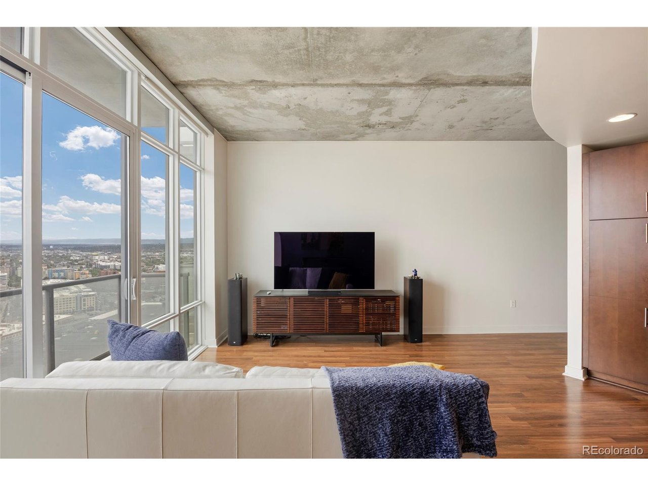 Experience elevated downtown living at SPIRE Denver, one of Denver's most sought-after high-rise communities in the heart of the city. Ideally positioned just steps from the Light Rail, Convention Center, shopping, dining, and entertainment, this stylish 1-bedroom, 1-bath residence offers the ultimate lock-and-leave lifestyle with exceptional city access and resort-style amenities.Upon entering, you're welcomed by thoughtful custom storage solutions, including a hallway storage closet and built-in custom closet system complete with a rolling ladder for convenient upper-level access. The open-concept floor plan is filled with natural light and framed by dramatic floor-to-ceiling windows showcasing sweeping downtown views.The expansive living room flows seamlessly onto a private balcony, creating the perfect outdoor space to enjoy the city skyline. The dining area is highlighted by a custom designer light fixture, while the kitchen offers granite countertops, a breakfast bar for casual dining or entertaining, a three-drawer refrigerator, and an electric smooth-top range for easy maintenance.The spacious bedroom features direct access to the laundry closet through a sliding door and includes a large walk-in closet with custom shelving systems. The full bathroom is well-appointed with updated fixtures and a tub/shower combination. Additional features include motorized blinds and a dedicated parking space. This pristine residence has been exceptionally maintained and thoughtfully updated throughout.Residents at SPIRE enjoy resort-style amenities across multiple levels, including two year-round heated pools, hot tub, fire pit lounge, state-of-the-art fitness center, movie theater/media lounge, dog park, 24-hour courtesy desk, and expansive resident gathering spaces. Located directly across from the Denver Performing Arts Complex and moments from restaurants, nightlife, and cultural attractions, this is downtown Denver living at its finest.