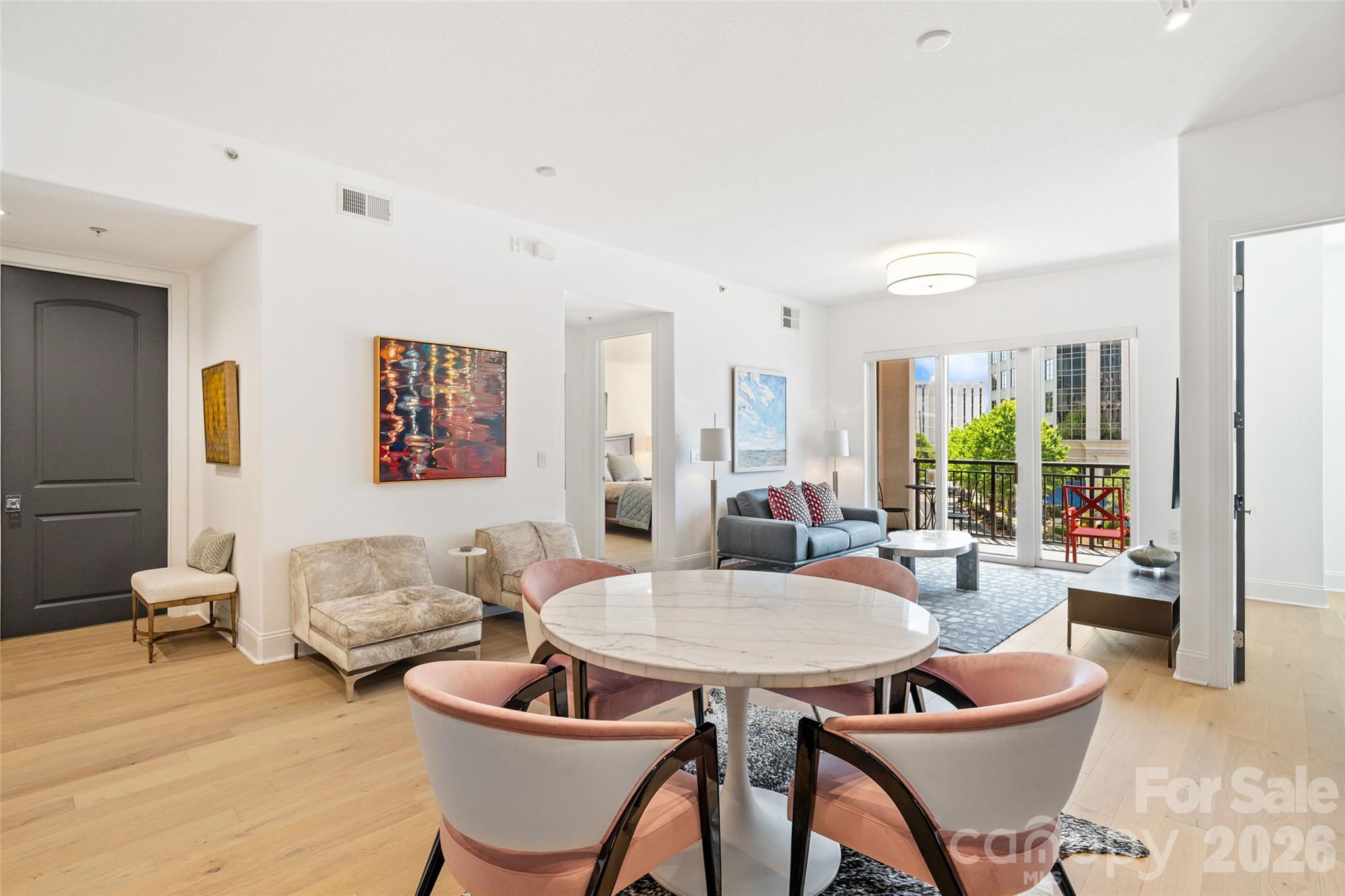 Welcome to this rare opportunity at Piedmont Row—the only fully renovated 2-bed, 2-bath residence currently on the market. One of only a few units with a direct, front-facing view of the community water fountain, this home offers beautiful year-round views and a prime position within the community. A dedicated storage unit adds another hard-to-find feature. Fully renovated throughout, the home features an open-concept floor plan, LVP flooring, and abundant natural light. The newly renovated kitchen includes high-end stainless steel appliances, updated countertops and backsplash, plus a stylish dry bar with a beverage refrigerator. All bathrooms have been thoughtfully updated with modern vanities and finishes. Sliding doors open to a generously sized balcony overlooking the fountain and vibrant Piedmont Row.Both bedrooms offer generous space and walk-in closets, while the split-bedroom layout provides added privacy. Two connected, gated and covered parking spaces are conveniently located on the same floor as the residence. Enjoy premier dining, coffee shops, fitness studios, personal care services, shopping, and entertainment just steps from your door. Community amenities include rooftop gathering spaces, a club and billiards room, and 24/7 security. With its unique fountain-facing location, full renovation, dedicated storage, and same-floor parking, this Piedmont Row residence is truly a rare find.
