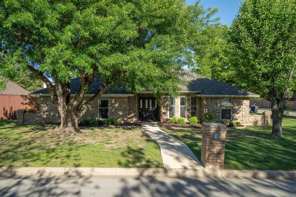 Cozy, single story home on a corner lot in Carroll ISD with a pool! Beautiful curb appeal with large trees in the front yard leading to covered front porch. Great floorplan with multiple living spaces for entertaining and enjoying lounge time in different areas. Sun room provides additional space coming in from the pool and spa. Nicely updated kitchen with white cabinets, new appliances and ample cabinet space including wet bar with a built in wine fridge. A formal dining space as well as eat in kitchen and bar stools by kitchen counter top providing multiple spaces to dine. Main living room features Beautiful beam accents on the ceiling, brick fireplace and wooden mantel. Additional living space could be used as an office, play room or other flex space uses.  Bedrooms located off of the hallway from the main living room. Large primary bedroom with updated vanity in bathroom. Neutral paint throughout.  Stepping outside of the sun room, enjoy the large pool and spa with beautiful landscaping. Outdoor storage shed. Fantastic location and neighborhood. Minutes away from retail, restaurants and schools.
