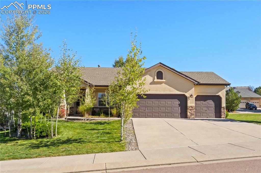 Welcome to this beautifully crafted home by Goetzmann Custom Homes, located in the highly desirable and picturesque Homestead at Jackson Creek. Tucked away on a quiet cul-de-sac, this home offers convenient access to nearby parks, playgrounds, and elementary school. This spacious residence features 5 bedrooms, a dedicated office, a formal dining room, and four full bathrooms, including a luxurious five-piece primary bath. Upon entry, you are welcomed by a private office with French doors and formal dining room that flows seamlessly into the gourmet kitchen. The main level is enhanced by stunning wood floors, rich dark Knotty Alder trim, doors, and custom window valance boxes, wrought iron railings, and brushed nickel hardware throughout. The kitchen boasts knotty alder cabinetry, raw-edge granite countertops, farmhouse sink, gas range, dishwasher, and built-in microwave and oven. The inviting living room showcases a stunning gas fireplace with custom mantle and opens to a private backyard patio, accessible from both the living room and the primary suite. The outdoor space offers a peaceful, private setting along with open space views that enhance the overall ambiance. Functionality meets convenience with a main-level laundry room featuring utility sink and close proximity to the spacious three-car garage. The primary suite provides a true retreat with a spa-like five-piece bath, including a soaking tub, large tile shower, and private water closet. The finished basement features high ceilings, large family room with second gas fireplace (both equipped with blowers), and three generously sized bedrooms—one with a private en suite bathroom. One of the bedrooms is currently utilized as a gym and includes LVP flooring. Additionally, the basement offers a large storage room, providing ample space for organization and seasonal storage needs. This home is filled with luxury finishes and thoughtful details throughout—an exceptional opportunity in a truly beautiful setting.