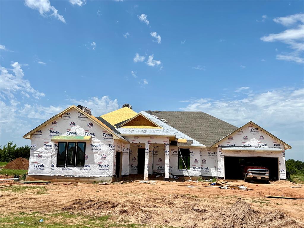 A Truly Stunning Floor Plan That Captures Timeless Elegance and Modern Design! From the moment you pull up, this home is sure to impress with its striking curb appeal and beautifully designed layout. Step through the front door and be welcomed by a wide, inviting hallway that leads into a massive living room. The centerpiece of this space is a gorgeous fireplace, tastefully accented by built-in shelving on either side, creating a warm yet sophisticated ambiance. The main areas of this home feature wood tile flooring, adding durability and style. The kitchen is a masterpiece of design and function, showcasing custom cabinetry reaching all the way to the ceiling, thick quartz countertops, under cabinet lighting, and floating wood shelving. A large decorative vented wood hood, premium stainless steel built-in appliances, and a spacious island make this kitchen as functional as it is beautiful. The oversized pantry offers ample storage to keep everything organized and within reach. The 12-foot glass sliding doors in the living room telescope open to reveal a sprawling covered patio, perfect for outdoor gatherings, relaxation, or enjoying the peaceful surroundings. The primary suite is your personal oasis, offering an enchanting loggia that connects the luxurious primary bathroom to a private study or retreat space. The primary bathroom features a freestanding soaking tub, a spacious walk-in tiled shower, a two-sink vanity, an enclosed water closet, and abundant storage. The expansive walk-in closet with a window is both practical and elegant. Every detail in this home has been meticulously crafted to combine beauty and functionality. Situated in a tranquil neighborhood with an outbuilding-friendly HOA, this property offers the perfect blend of peaceful living and thoughtful design. Don’t miss the chance to make this extraordinary home your own—schedule your private showing today!