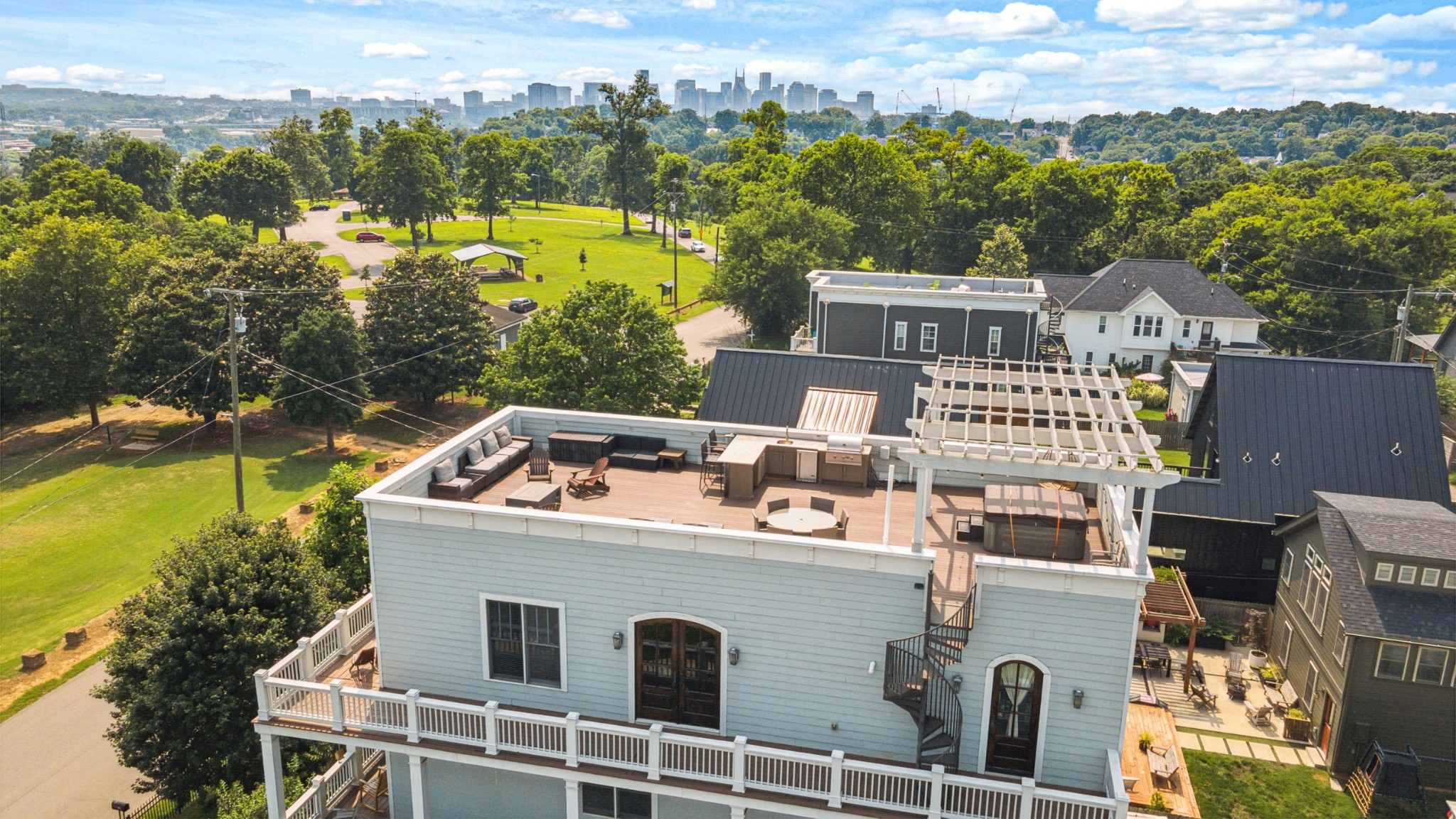 Here is your chance to own one of the most unique properties this close to downtown! Ultimate city living! This home offers a prime location - Shelby Park IS your front yard. Did we mention the rooftop deck with panoramic views of the skyline? Designed for those who love to entertain, as well as those families who cherish a variety of spaces, including 3 wrap around porches, a large rooftop, and multiple indoor areas perfect for gatherings.

The rooftop deck has it all: a hot tub, pergola, grill, a cozy fire pit, and those amazing views of downtown. Step outside and you’re a short walk from Shelby Bottoms greenway, the golf course, and popular spots like Frothy Monkey and Lockeland Table.

Every corner of this home provides unique charm. It feels like Charleston in the midst of Nashville and is crafted with elegance and functionality — multiple wrap-around porches, fenced front and back yard, three-car garage, gorgeous hardwood floors, inviting fireplaces, marble countertops, and wood beams. This home has an abundance of character and modern amenities, making it a must-see!