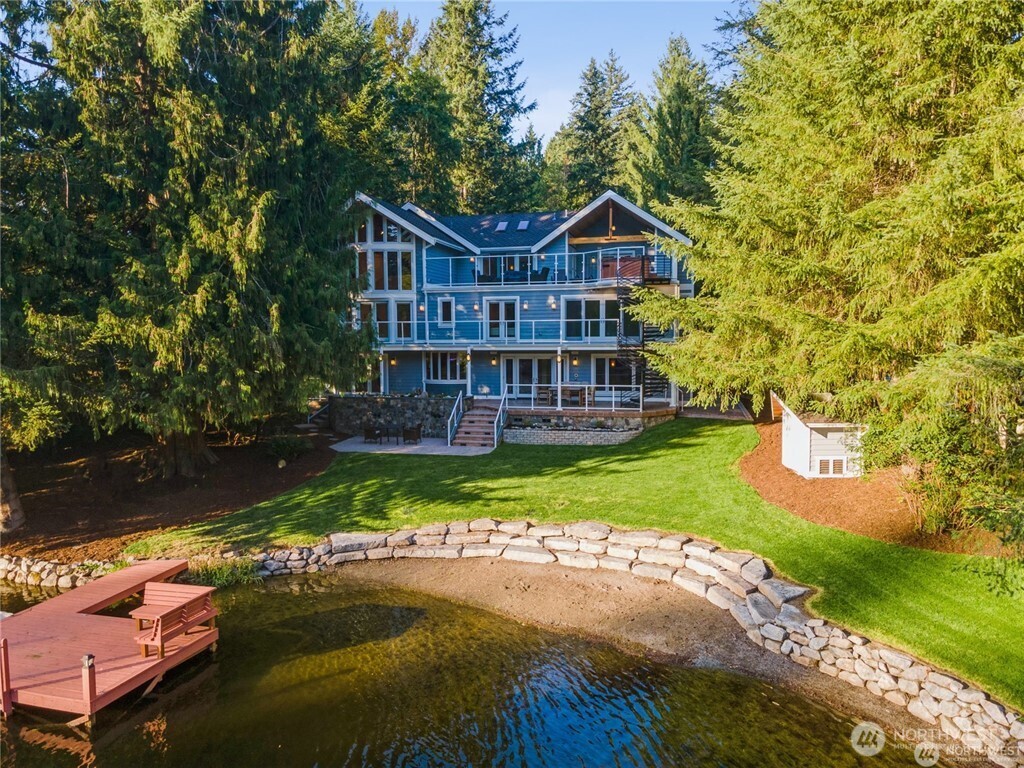 Exceptional opportunity to own a custom, meticulously maintained & move-in ready home on coveted Lake Marcel. Set on a manicured 17,000 SF private lot. This Luxurious Lake Marcel home has 3 stories all with beautiful lake views situated on 135' of waterfront with its own designed rockery wall & sand beach for entertaining. The home has over $4 million in incredible custom designed construction from the main level to the top 3rd floor, sparing no expense on materials/appliances & craftmanship. Impeccable millwork, marble/granite & woodwork featured throughout the home. Grand Formal Entertaining Areas. Chef's kitchen w/Dacor & Sub Zero beautiful appliances, custom cabinets/millwork. Family Room w/Elegant shelving accented by F/P. French doors open to the expansive waterfront and covered patio for entertaining. Primary Suite boasts a 2-story bow/bay wall of windows, gorgeous, vaulted wood ceiling. Comfortable sitting room w/fireplace/tv. One of a kind wet room for the spa experience with heated marble inlay flooring. Beautiful cabinetry with honed marble bathroom counters. Separate Family Wing has it all with two bedrooms with their own private bathrooms & large bonus room. The third floor boasts vaulted ceilings throughout with an Executive office/boardroom. Exercise Room and Huge Media Room that opens to a 700sq' entertaining deck w/hot tub, bathroom, kitchen nook & unobstructed lake views. Perfect to retire to the 6-person hot tub & watch the stars and satellites. BUILT 2008