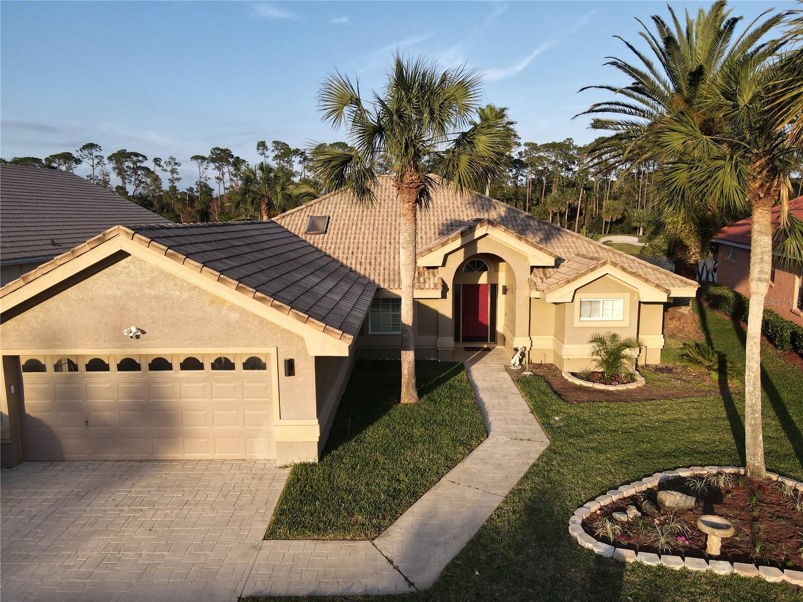 Welcome to 417 Long Cove Road, a beautiful 3-bedroom, 2-bathroom home located in Plantation Bay community of Ormond Beach, Florida. This spacious residence offers 2,175 square feet of living space, providing ample room for comfortable living. Upon entering, you'll be greeted by an open floor plan featuring high ceilings and abundant natural light. The formal living room boasts tile floors and large windows, creating a bright and inviting atmosphere. Adjacent to the living room is a formal dining area, perfect for hosting gatherings. The kitchen is equipped with stainless steel appliances, granite countertops, and a breakfast bar, making it ideal for both cooking and entertaining. A cozy breakfast nook offers serene views of the pool area. The family room features wood plank tile floors, a gorgeous Lake view and built-in shelving, providing a warm and welcoming space to relax. ContinuedThe master suite is a private retreat, complete with wood plank tile flooring, sliding doors leading to the lanai, a tray ceiling, and a walk-in closet. The en-suite bathroom has been remodeled to include granite countertops, new soft-close cabinets, a walk-in tile shower, and a soaking tub. Additional bedrooms are spacious and well-appointed, offering comfort and flexibility.Step outside to discover a renovated pool area with a pavered lanai, and pebble tech finish, all overlooking a large, private yard. Located on a cul-de-sac, this home offers both privacy and tranquility. As a resident of Plantation Bay, you'll have optional access to amenities such as golf courses, tennis courts, and clubhouses, enhancing your living experience.Available to rent NOW