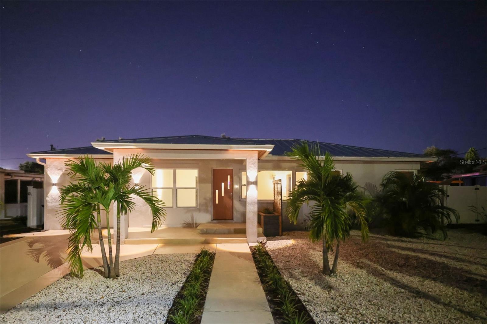 Live the Ultimate Dunedin Lifestyle! Experience the true essence of Dunedin living at 2012 Culberson Ave—where modern design, smart technology, and tropical tranquility meet. Perfectly positioned with views of the Dunedin Golf Club and Highlander Park, this 4-bedroom, 2-bath, 1-car garage home offers 2,432 heated square feet of high-end craftsmanship and effortless Florida charm. Just a short golf cart ride to Downtown Dunedin’s waterfront, restaurants, and boutiques, this location delivers the ultimate blend of serenity and convenience.

This property combines the best of new construction that has an addition made with block construction and designer renovations, featuring all-new electrical and plumbing, a high-efficiency Daikin A/C system with all-new ducts and registers, impact windows and doors, and a Level 5 drywall finish throughout. Inside, the open-concept layout showcases solid cherry cabinetry, custom white cement countertops, smart appliances, and an oversized kitchen island that seats six, creating a warm and stylish heart of the home.

The interior also boasts original hardwood and hypoallergenic concrete flooring, a smart LED fireplace, Lutron lighting and dimmers, and European-inspired bathrooms with curbless showers and wall-hung toilets. Convenient indoor laundry adds everyday functionality, while thoughtful design details make every space feel elevated and intentional. The addition features over 9 foot ceilings, which includes the primary suite, primary bath and additional bedroom or office.

From the primary suite, guest quarters, and kitchen, pocket sliders open directly to your private backyard oasis—a resort-style retreat where it feels like vacation 365 days a year. The smart pool and spa feature color-changing lights, deck jets, and high-end pavers, surrounded by lush zero-scape tropical landscaping in both the front and back yards. The cabana off the addition serves as the ultimate recreation lounge, perfect for a poolside game room, home office, or guest retreat.

A unique flex space by the pool adds incredible versatility—it can serve as a recreation room, additional bedroom, home office, den, or cabana suite. Other premium features include a new high-level metal roof with rafter tie-downs, foam-insulated attic, custom stained wood soffits, smart garage door opener, and freshly sealed driveway, sidewalk, and porch.

With all possible insurance credits, no flood zone, and every modern upgrade imaginable, this home truly defines luxury coastal living in Dunedin—where every day feels like a getaway.