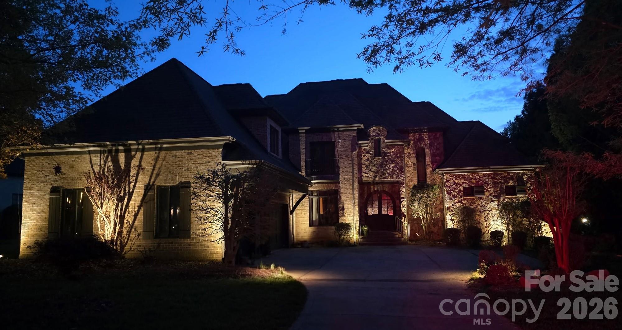 Located in the exclusive gated community of Chatelaine, this full brick custom home offers refined living with exceptional space, craftsmanship, and views. Double curved mahogany doors set the stage for this custom home, showcasing quality construction with rounded wall corners, real wood floors, oversized rooms, heavy trim, fresh paint, and all-new carpet. The main level features an open, functional layout ideal for both everyday living and entertaining. The grand foyer overlooks the formal living room with a coffered ceiling, large windows that bring in an abundance of natural light, and a see-through gas fireplace. The high-end chef’s kitchen is well-appointed with Viking appliances, including a gas cooktop with grill, wall oven, microwave, and dishwasher, complemented by a 48” Sub-Zero refrigerator, granite countertops, and a center island with prep-sink. The kitchen flows seamlessly into the breakfast area and spacious great room with a fireplace, all with direct access to the rear deck overlooking the backyard and community pond. A formal dining room connects to the kitchen via a butler’s pantry for added convenience. The oversized main-level primary suite with tray ceiling offers privacy and comfort, while the spa-like bath with dual vanities, soaking tub, and tiled shower provides a relaxing retreat. The walk-in closet features custom built-ins. A well-placed laundry room with sink and a drop zone is located off the oversized three-car garage—complete with a separate storage room which enhances everyday functionality. Dual staircases lead to a versatile upper level featuring a bedroom with an ensuite bath, two additional bedrooms connected by a Jack-and-Jill bath, a loft area, and a flex room with walk-in attic access—ideal for an office, playroom, or quiet space. A large billiard room includes access to a powder room for guests. The media/theater room is equipped for movie nights and entertainment with a screen, speakers, equipment, and a wet bar. Outdoor living is highlighted by a private backyard with direct pond and fountain views, along with landscape lighting—an ideal setting for entertaining. Zoned for top-rated Weddington schools, this home combines timeless design, thoughtful layout, and a premier location.  Don’t miss out on this beautiful and functional home.  Make your appointment Today!