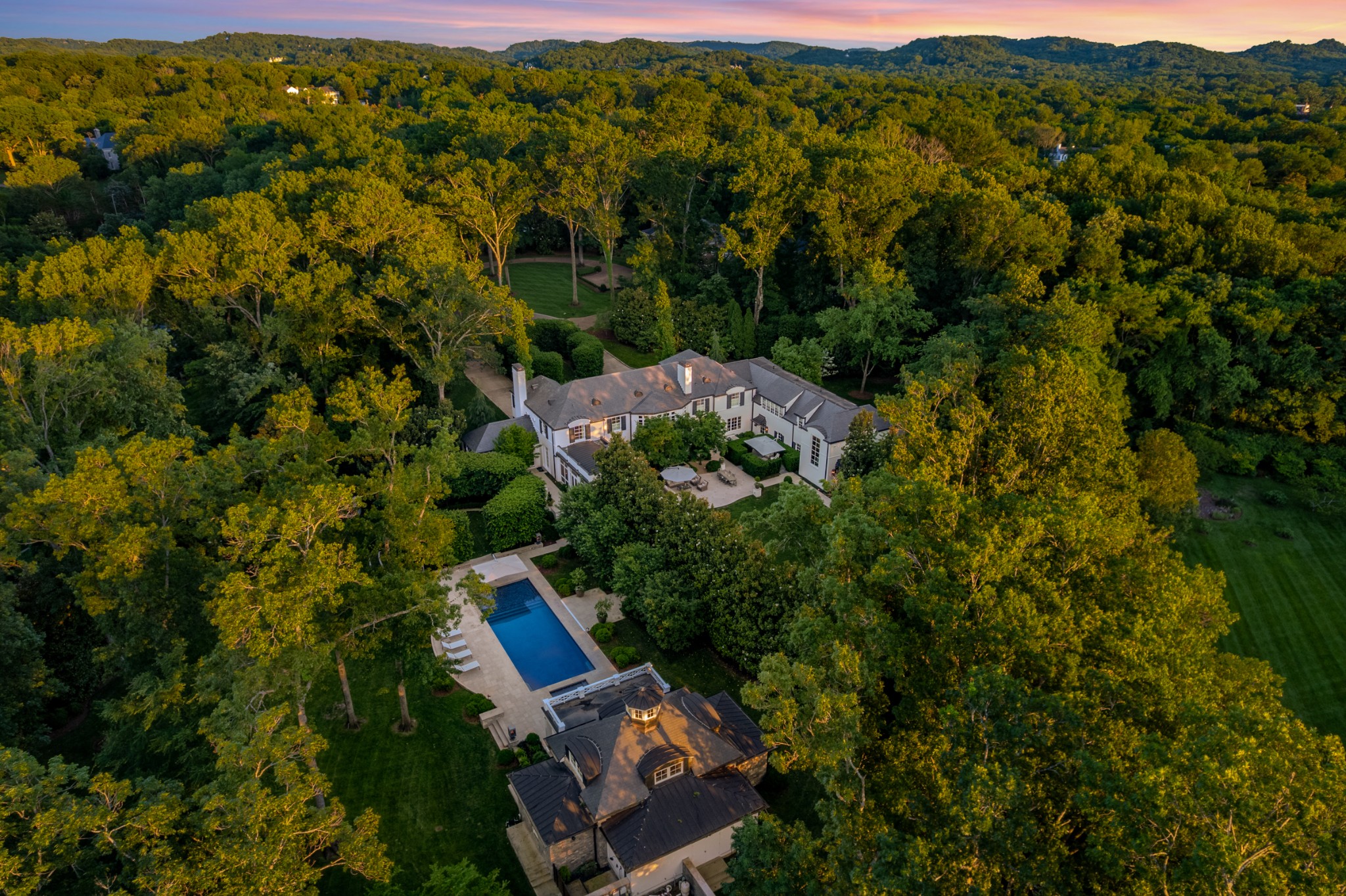 This remarkable Edwin Keeble designed Belle Meade Estate situated on 2.45 flat, park like acres is nothing short of breathtaking. Originally built by John Ramsey in 1970, then meticulously renovated to the studs with architect Jamie Pffefer and Phipps Builders in 2015. A large addition to the main home as well as adding a pool and pool house completed this spectacular property. This epitomizes quiet luxury and chic sophistication. Located at the end of a dead end street, this is the ultimate in private Belle Meade living. Georgian Limestone pathways, flanked by Georgian Sunset Gravel lead you through the award winning landscape design of Gavin Duke. Renowned Arborist Tom Powers sourced over 350 tree specimens from various states to create a green oasis offering complete privacy year round. Enjoy any weather from the screened in porch with wood burning fireplace, barrel ceilings and built in heaters. Should the rain running off the slate roof and into the copper gutters get worse, then the 150KW generator will kick in to supply power to the entire home, pool house and pool. All electrical ,plumbing and insulation redone in 2015 renovation. Geothermal HVAC system added, brand new windows and doors made in a Georgia mill workhouse to recreate exact replicas as Edwin Keeble originally designed. A breathtaking Moongate created on site with Texas Limestone boulders sourced by Harry Peffen. The Primary suite has proper his and hers bathrooms and walk in closets, heated floors and sweeping views on the property.  All secondary bedrooms have en suite bathrooms with heated floors. Additional features include but are not limited to: an elevator, groin vaulted ceilings, Crotch Mahogany paneling, his and hers office spaces, raised flower beds, outdoor shower, gas fire pit, irrigation system, security system, Lutron lighting, and so much more. Please contact agents for showing opportunities. Buyer and buyers agent to verify all facts. POF required. Please allow 24 hr notice.
