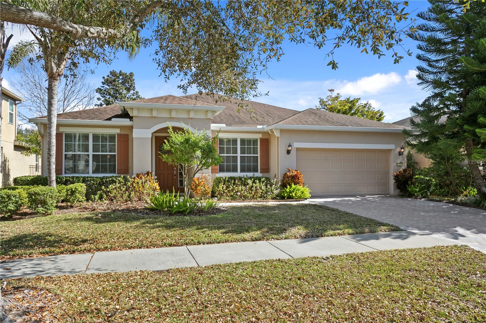 **Take a VIRTUAL VIDEO TOUR of this home now at www.3205MajesticViewDr.com** Welcome home to this impeccably maintained 2012 home in the highly sought after gated Waterbridge section of Stonebrier in beautiful Lutz, FL.  Located on a non-flood zone lot, this home is zoned for one of Hillsborough county’s premier school districts – all A-rated schools (McKitrick/Martinez/Steinbrenner)! With over 2,600sqft of living space, this move-in-ready home features 4 bedrooms, 3 baths, a tandem 3-car garage. As you enter the paver driveway, you’ll find this beautiful painted ranch home with fantastic curb appeal and carefully manicured landscaping that provides a great welcoming entrance. Enter through the front door into a spacious foyer and you’ll find a 3-way split bedroom floor plan, high ceilings, crown molding and 20-inch diagonal ceramic tile floors.  Just off the foyer, graceful arches open up to the formal living room and huge formal dining room.  On the opposite side of the foyer is the 4th bedroom and 3rd full bath that features granite counters and a tub/shower combo.  Further down the foyer is an expansive kitchen that includes a massive breakfast bar with seating up to 12, thick granite counters, 42” staggered wood cabinets, upgraded stainless appliances including a convection oven and French door refrigerator and a built-in desk.  The open-concept floor plan continues from the kitchen to the family room that offers sliding glass doors out to the covered lanai and backyard. Step outside to your tumbled travertine pavers on the covered lanai with a ceiling fan and beyond is a separate paver patio with artificial turf for additional outdoor living spaces and enjoying the firepit in cooler weather.  Mature landscaping completes the backyard, making it the perfect place to relax with family and friends. Head back inside to the primary suite with direct lanai access. The primary bath includes dual sinks with make-up station, granite counters, a garden tub, separate frameless glass shower and walk-in closet with a custom closet organizing system.  The 2nd and 3rd bedrooms are on the opposite side of the home and share an updated full bath with granite counters and a tub/shower combo.  Additional upgrades include a BRAND NEW water heater, California Berber carpet in all bedrooms, surround sound pre-wire in the family room, large laundry room with upgraded cabinets, utility sink and premium Maytag washer/dryer included, new garage door opener, additional 220v electrical outlet in the garage for EV fast charging, upgraded LED lights and multiple smart light switches, garage attic storage space with drop-down ladder & more! Enjoy resort quality community amenities in Stonebrier including a zero-depth pool w/splash area, waterslide, poolside cabanas & lounge chairs, playground & 24-hr fitness center. Stonebrier also features community basketball, soccer & cricket fields along w/lots of lakes, ponds & conservation views.  Peace-of-Mind included with a Seller-paid 1yr home warranty at closing.