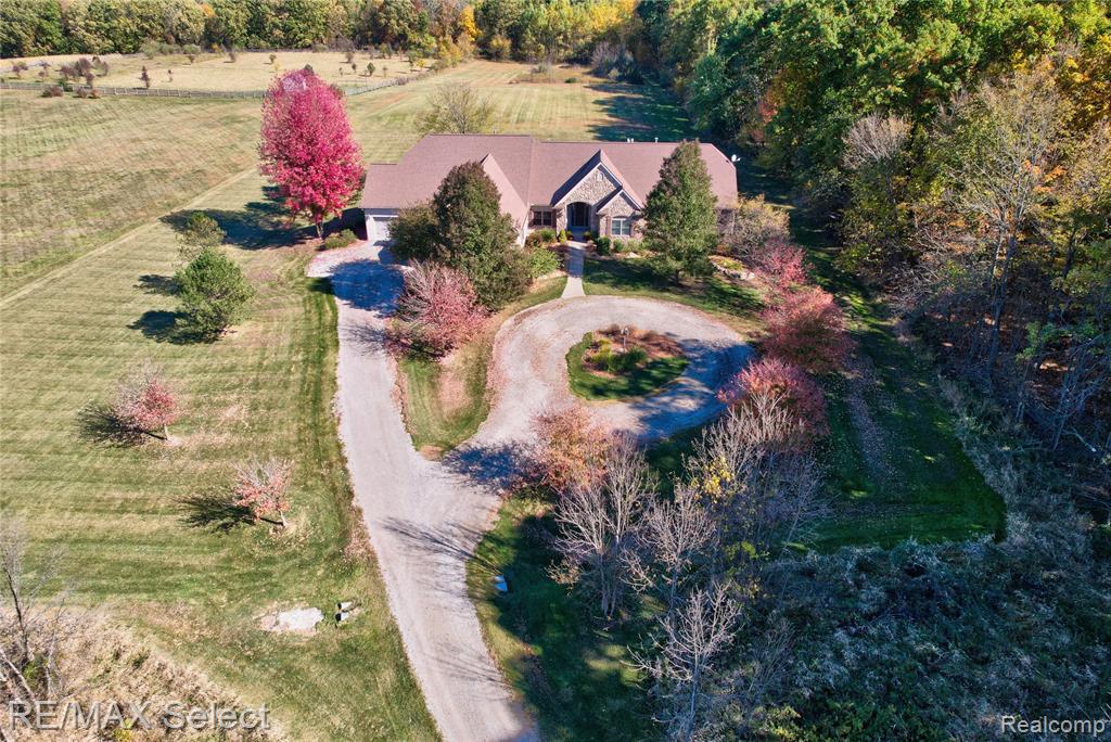 Welcome to an exceptional custom ranch nestled in a beautiful country setting on 10 sprawling acres! Surrounded by open space and privacy, this property offers the ideal balance of peaceful rural living with convenient access to nearby amenities.This beautiful home offers over 5,700 sq ft of finished living space, including a daylight lower level designed for both entertaining and everyday living. The main level features an open, flowing floor plan with hardwood flooring, expansive living spaces with multiple fireplaces, and a bright, open kitchen with stainless steel appliances, abundant cabinetry, and generous counter space—perfectly positioned to overlook the dining and living areas.The primary suite provides a private retreat with ample space and an ensuite bath, while additional bedrooms are thoughtfully arranged for comfort and flexibility. The finished basement is an entertainer’s dream, featuring a home theater/media room, billiard area, 3 bedrooms, an office, a full bath, and an additional fireplace—ideal for guests, recreation, or multigenerational living.The 4-car attached garage with direct access, offers plenty of room for vehicles, equipment, and storage. Don't miss out on this is a rare opportunity to enjoy country living on a large lot with space, privacy, and quality throughout.