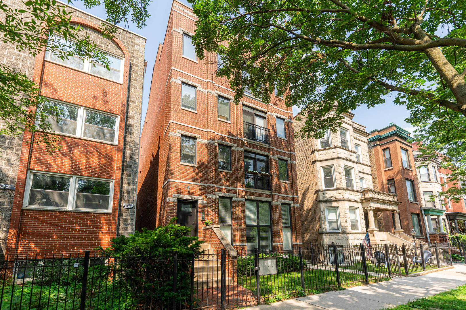 Spacious All-Brick Condo in Prime East Lakeview Location!  Welcome to this stunning 1600+ sq ft home in an intimate 4-unit building set on an extra-wide 30 ft lot. This move-in ready condo features an open-concept layout with a sunlit living room, dining area, and kitchen - complete with Juliet balcony windows and a cozy fireplace.  Enjoy the ideal split-bedroom floor plan with two generously sized bedrooms and two full bathrooms. The luxurious primary suite boasts a walk-in closet and spa-inspired bath with a whirlpool tub, steam shower, and double vanity. Hardwood floors run throughout, and the unit also includes a side-by-side laundry room, spacious deck, storage and tandem exterior parking included!  The open layout is perfect for entertaining-featuring a chef's kitchen with Viking stove, Sub-Zero refrigerator, granite counters, stainless appliances, and breakfast bar. Tucked away on a quiet one-way street just two blocks from iconic Wrigley Field, and a short walk to the lakefront, shops, dining, and nightlife. Easy access to the Clark Street bus and Red Line at Addison makes commuting a breeze.  A rare combination of space, style, and unbeatable location - don't miss this East Lakeview gem!