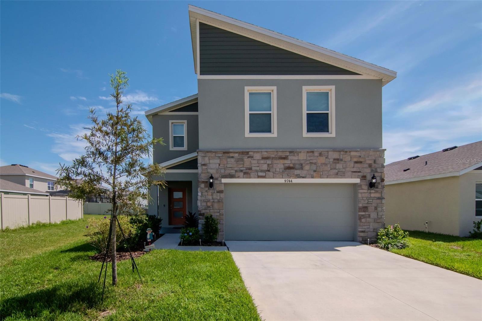 Welcome to Epperson and the Epperson Lagoon lifestyle. This 4 bedroom 2 1/2 bath home has an open floor plan and is situated on one of the few community's ponds with  grassed easements to the left and back of the property. The front foyer leads to a bright and sunny living area open to the kitchen and dining areas. In the kitchen modern shaker cabinets with white solid surface counters are accented by stainless steel appliances and tiled backsplash. The large island has bar seating for four while the dining area can host 6 to 8 people easily. From there, sliding glass doors lead to an outside 18 X 24 caged screened in lanai. This outdoor room overlooks the pond and has a dining and entertaining area. This is over 400 square feet of extra outside enjoyment! The second floor is anchored by an open loft area at the top of the stairs, perfect as a den or play area. The primary bedroom with en-suite bathroom has a walk-in closet. There are 3 additional bedrooms, second full bath and laundry room on this level. A part of the Epperson lifestyle is of course Epperson Lagoon, a 7.5 acre resort style man made lagoon with beaches, water activities and dining options. The community also has play grounds and natural trails throughout. Located in the fast growing area of Wesley Chapel, Epperson is close to many shopping and mall options, with easy access to I-75, I-275 and Tampa International Airport. Make an appointment to see your future home in this great community.