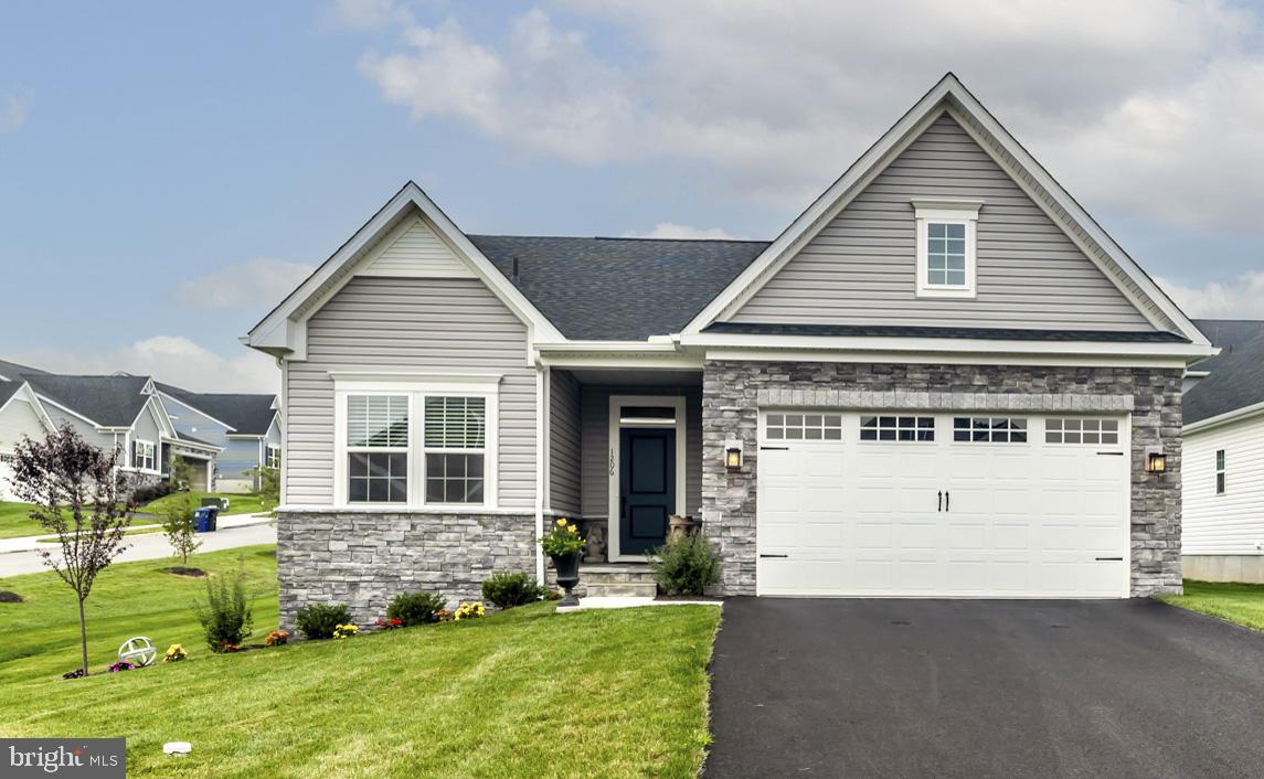 Why wait for new construction when this beautifully finished 2025 Craftsman-style home is ready for you now? Welcome to 1206 Gilray Drive in Brandywine Walk, a sought-after 55+ community offering low-maintenance living without sacrificing space, style or the ability to entertain family and friends. With 2 bedrooms plus a main-level office/flex room, 3 full baths and 2,399 square feet of finished living space, this detached single home offers the look and feel of new construction—with the upgrades and additional finished space already in place.Stone accents, attractive landscaping and an attached two-car garage create a welcoming first impression. Step inside to a bright, open main level with 1,421 square feet designed for easy one-floor living. The beautifully appointed kitchen features crisp white cabinetry, quartz countertops, stainless steel appliances, subway tile backsplash, recessed lighting and a generous center island with seating. The kitchen flows seamlessly into the dining area and spacious great room, where a gas fireplace with classic mantel creates an inviting focal point. Abundant windows fill the space with natural light, while sliding glass doors extend the living area outdoors.The covered rear porch is a wonderful place to start the morning or unwind at the end of the day, complete with maintenance-free decking and railing, recessed lighting and a ceiling fan.The main-level primary suite provides a comfortable private retreat with a spacious bedroom and ensuite bath featuring a long dual-sink quartz vanity, abundant storage and an oversized tiled shower with glass enclosure. A second bedroom and full hall bath provide comfortable accommodations for guests, while a separate office with egress offers valuable flexibility for working from home, hobbies or additional guest space. A dedicated laundry room with generous shelving and storage adds to the convenience of true main-level living.But the living space doesn't stop there. The 978-square-foot finished lower level dramatically expands the possibilities with an impressive recreation and entertaining area and a fabulous wet bar featuring quartz countertops, extensive cabinetry, glass-front display cabinets, wine storage, stemware rack, sink, under-cabinet lighting and seating for four. Whether hosting a crowd, watching the big game or simply relaxing, this is a space designed to be enjoyed. A third full bath, egress and large separate storage room add even more functionality.Built in 2025 and beautifully finished from top to bottom, 1206 Gilray Drive offers 2,399 finished square feet, a main-level primary suite, exceptional entertaining space and the opportunity to enjoy the Brandywine Walk lifestyle today—not months from now. Why build, wait and add the extras later when it’s all here and ready to go?