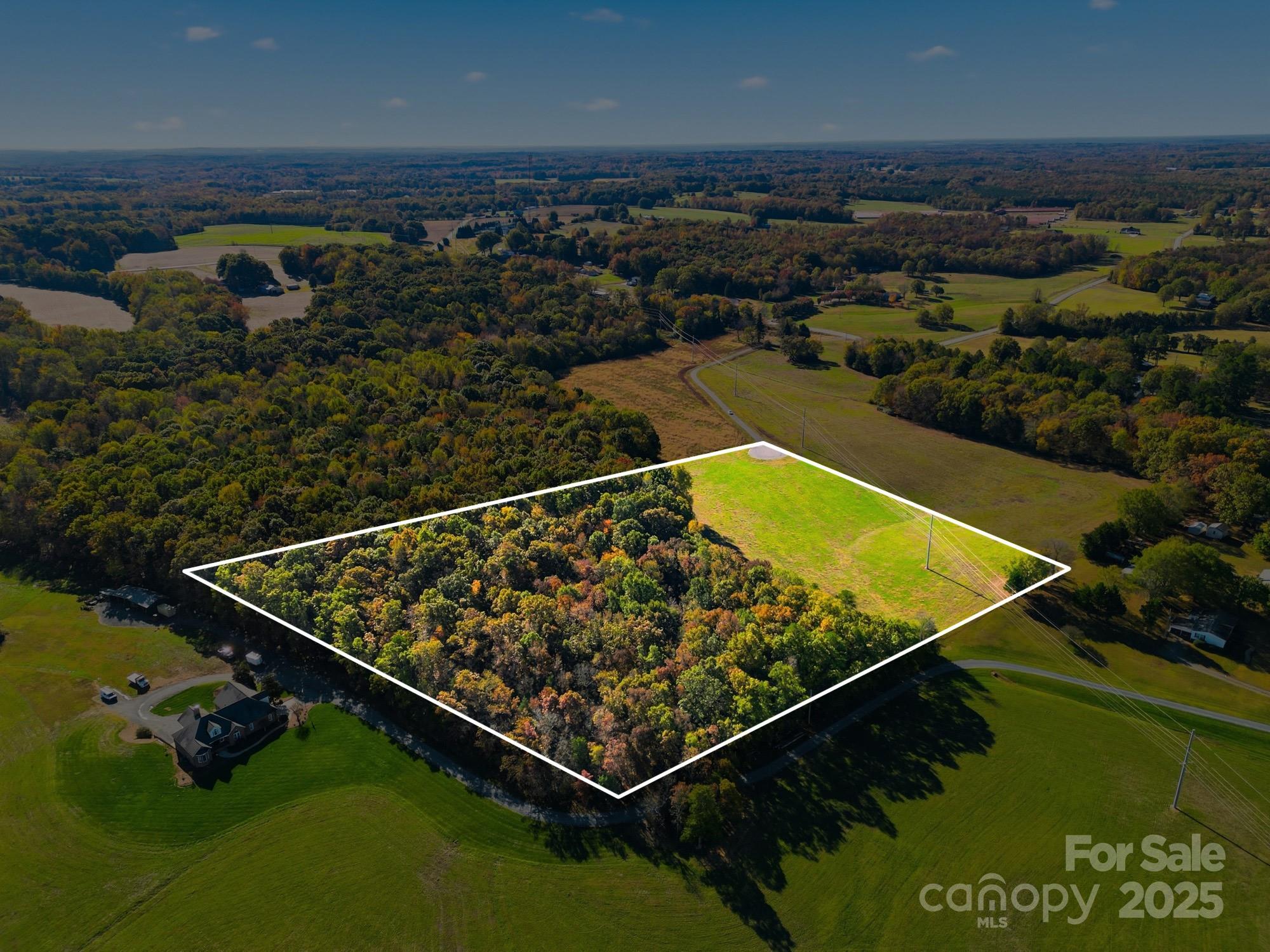 Where open meadows meet quiet woodlands, you’ll find this nearly 10.5-acre retreat in Stanly County… a rare blend of natural beauty, privacy, and build-ready convenience. With a 4-bedroom septic permit already issued, your dream home can take shape without delay. Lot 4 is ideally positioned at the end of a private paved road, offering the best of both worlds… peaceful seclusion and easy access. The property’s layout features both open grassland and mature woods, providing the perfect mix of sun & shade… open views & quiet cover. Imagine living on land where mornings feel slower, wildlife still wanders freely, and the only sound you’ll hear is the rustle of leaves and maybe the call of a wild turkey. Whether you're envisioning a farmhouse with a wraparound porch or a modern retreat tucked among the trees, this land offers room to breathe and the freedom to design the life you’re longing for. No HOA… just pure, peaceful country living. Come walk the land, feel the stillness, and see for yourself why this property stands out among the rest… a rare find that feels worlds away, yet close to everything you need. Property is located near the intersection of Coley Store Rd & Mission Church Rd. From Hwy 24/27 in Locust, turn onto Coley Store Rd. At the end of Coley Store Rd, turn right on Mission Church Rd... Birdhouse Ln is immediately on the left.