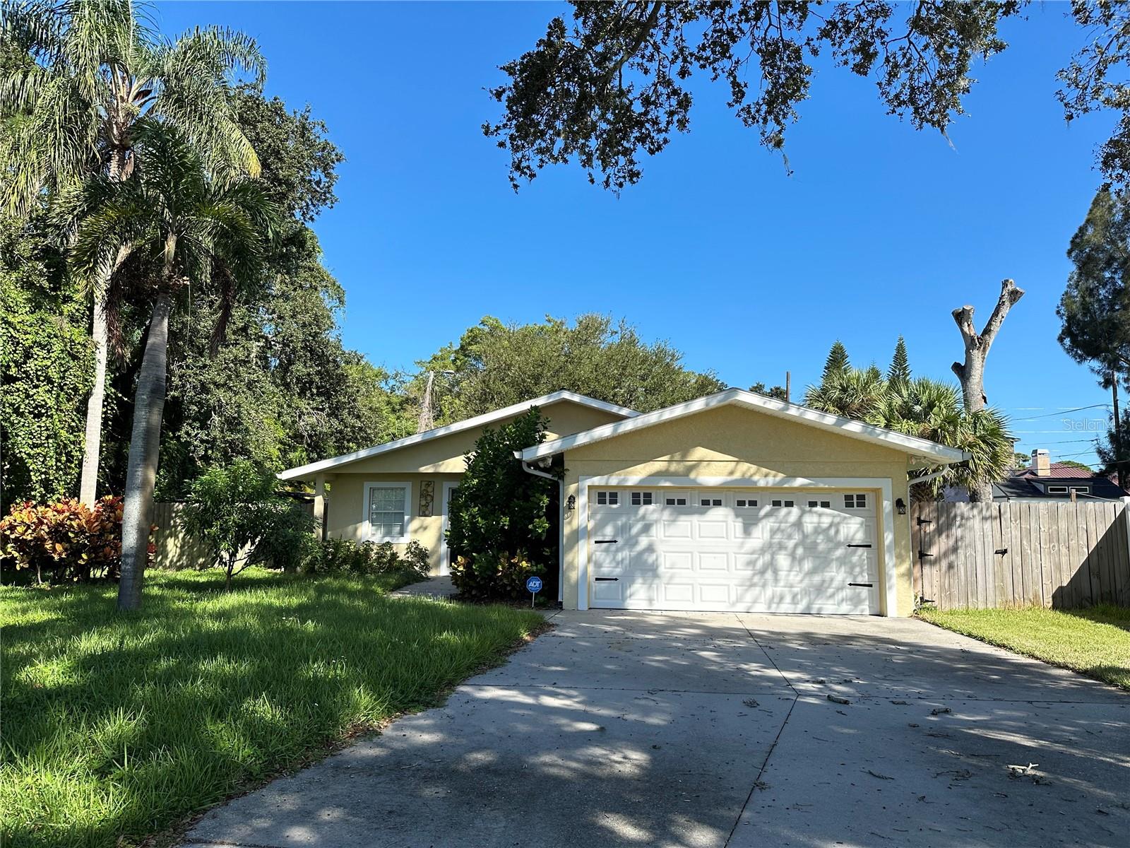 Short Sale. Short Sale, price and terms contingent approval by seller's lender.  Live in Belleair on nearly 1/4 acre! This 3 bed 2 bath, two car garage home located on a quiet street with a beautiful oversized lot is ready for you to call home.  The large primary suite includes a large ensuite bath with  ample space.  The kitchen, overlooking the living room offers an open floorplan.  The large fenced yard includes excess side yard, vacated by the city to the parcel, equipped with bird coop. Make an offer before it's gone!