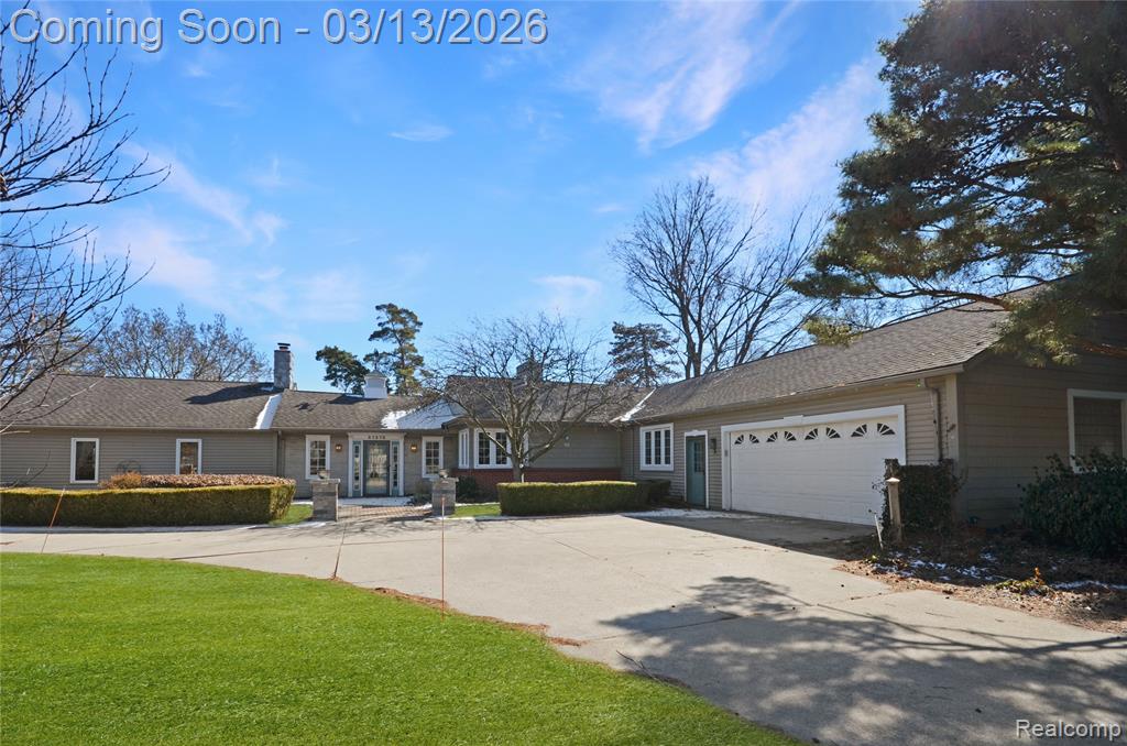 This is truly one of the most unique and beautiful homes you’ll find in the highly sought-after Moravian  Millar area. Offering over 2,500 square feet, this sprawling ranch sits on a beautifully landscaped lot of over half an acre providing both space and privacy. Prepare to be blown away by the stunning 25x25 half-log great room featuring soaring beamed ceilings, rich pine refinished flooring, and a breathtaking two-way stone fireplace that anchors the entire space.  The adjacent living room shares the split-stone fireplace and features a custom mantel and surround, built-in bookcases, and a door wall leading to gorgeous brick paver patios and walkways. The dining area showcases custom paint and detailed woodwork, adding warmth and character. The kitchen has designer cabinetry, updated granite countertops and backsplash, under-cabinet lighting, a pantry, stainless steel appliances and a built-in bench with tile table that will remain with the home. You’ll love the bright and cheerful laundry room with excellent storage and an adorable mudroom setup. Additional highlights include 200-amp electrical service with an electric vehicle hookup and an oversized 26x26 garage with full wall and overhead storage. Both secondary bedrooms are ideally positioned near the newly updated main bathroom, which features a clean, timeless design with subway tile, an oversized vanity, and decorative tile flooring. The romantic primary suite offers its own gas fireplace, custom plaster moldings, and a large window overlooking the private backyard. The primary bath includes a stall shower and a customized walk-in closet. This home combines rustic charm, custom craftsmanship, and generous living space in one incredible setting offering a serene, cottage-inspired feel right here in Clinton Township.  You won’t be disappointed.