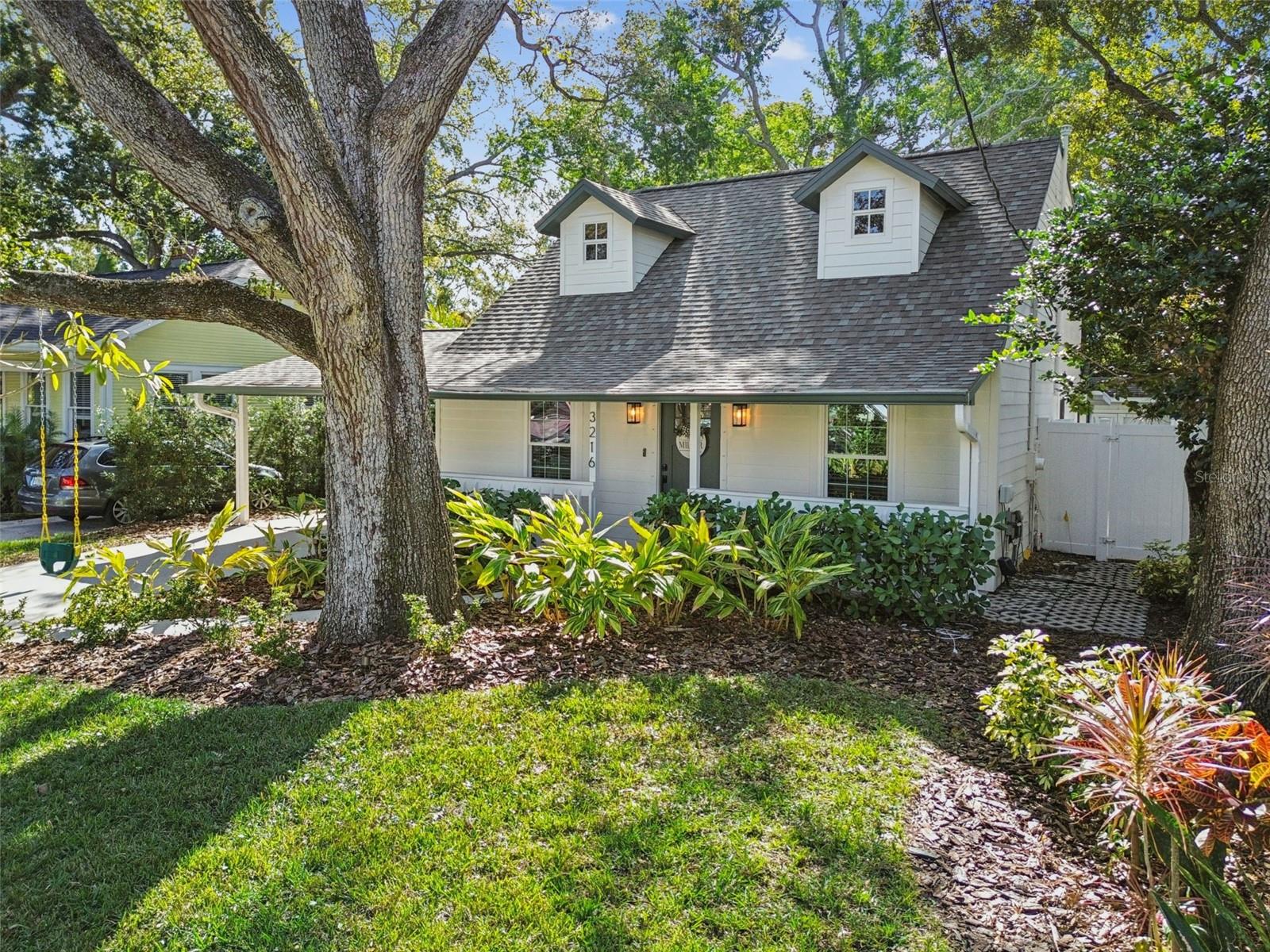 Under contract-accepting backup offers. This charming home straight out of a storybook is located in the highly-regarded Bayshore Beautiful neighborhood (Flood Zone X) and just three blocks from Bayshore Boulevard. Completely reimagined in 2022 with everything done from a full interior renovation, new Low-E double-paned windows, fiber cement siding, roof, HVAC, and more. It has been lovingly-maintained with even more upgrades since, and is truly move-in ready. The welcoming curb appeal and front porch sets the tone for what’s to come inside. Enter to a two-story living room with soaring ceilings, a shiplap feature wall surrounded by custom built-ins and anchored by an electric fireplace. The kitchen features sleek Quartz countertops, stainless steel appliances, and a breakfast bar and dining area. The primary bedroom suite is on the first floor with a custom built out closet and an en suite bathroom. Upstairs features two spacious bedrooms and another full bathroom. The outdoor living space is ideal with a screen-enclosed brick-paved lanai overlooking the turfed backyard. A beautiful blend of comfort, convenience, and style, you’ll never want to leave. There is a carport with direct covered access to the home and a storage shed- you won’t even miss a garage! Enjoy being close to the vibrant MacDill Avenue with its shops and dining destinations and having easy access to Publix, Target, Gandy Blvd, and the Selmon Expressway, making it a great location for everyday living and commuting. Schedule your private showing today!