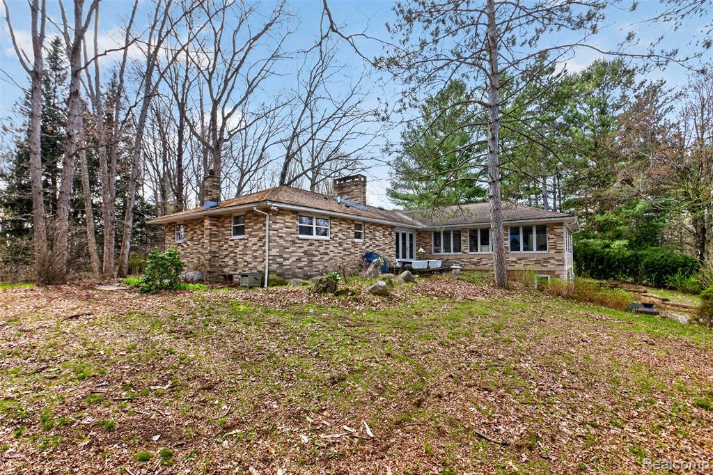 Private country retreat on 20 acres! This ranch-style home sits tucked back off the road and offers 3 bedrooms with potential for a 4th bedroom, 3.5 bathrooms, and scenic views throughout. Inside, you’ll find comfortable living spaces, a distinctive lower-level bar area, and sun-filled rooms overlooking the pond and wooded acreage. Outside, the property is loaded with extras including two pole barns, additional outbuildings, and a solar panel system. Whether you’re looking for privacy, storage, hobby space, or a one-of-a-kind setting, this property has it all.