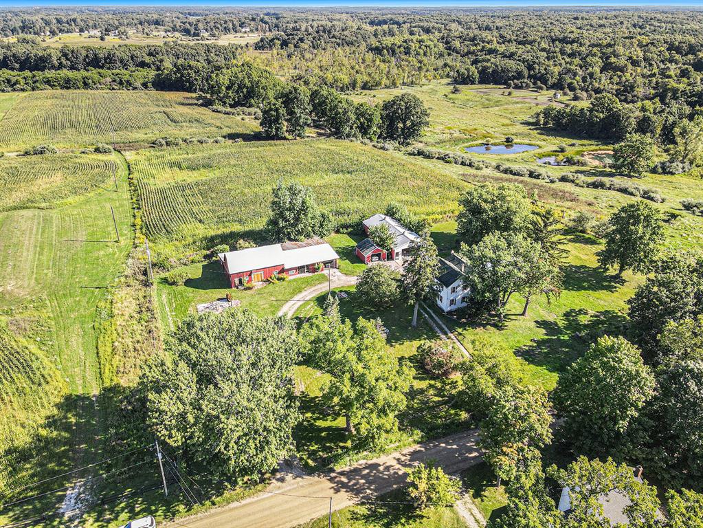 This remodeled farmhouse blends modern amenities with historical charm while offering the possibility of a hobby farm on 5 acres. Preserved timeless details are found throughout like the refinished original wood floors and upcycled wood features. The floorplan has been upgraded to offer a massive primary bedroom and ensuite with stone floors. Main level laundry, luxury Bertazzoni kitchen and a well-appointed half bath adjacent to two bedrooms on the upper level. The unfinished basement is a great place to store all of your fresh canned goods from the garden and fruit trees, with easy walkout access. Bring your tractor and fill up from the on-site diesel fuel tank. The backyard is fenced with a separate goat house and pasture approx. 160'x45'. Refresh yourself this summer in the Kayak Pool with new liner. Must see to appreciate all this property has to offer. A/C & furnace 2yr old, septic new in 2023. Roof 6yrs old.