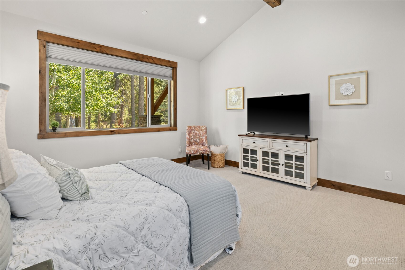 Oversized primary bedroom with vaulted ceilings