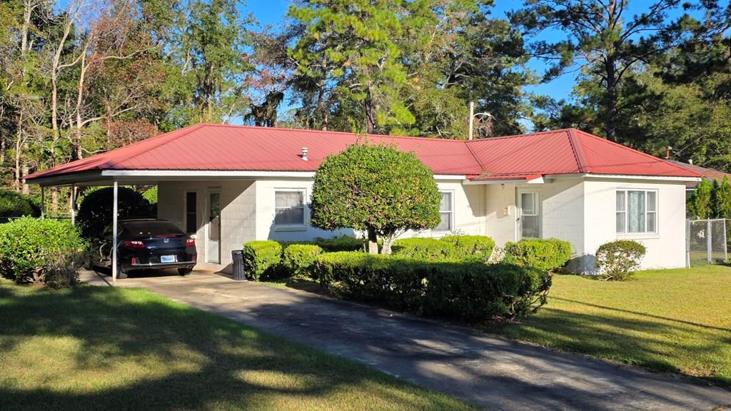 This solid block residence presents a fantastic opportunity for those looking to add their personal touch. Featuring three bedrooms and a versatile office that could easily serve as a fourth bedroom, this home offers flexibility for growing families or work-from-home professionals. The durable metal roof ensures longevity and peace of mind, while the inviting backyard promises outdoor activities or simply relaxing. Inside, unleash your creativity as you embrace the chance to update and customize to match your style with cosmetic remodeling of the kitchen, bath, flooring, light fixtures and paint through the FHA 203k program. Conveniently located close to local schools, parks, hospital and dining options, this property is perfect for those seeking both comfort and convenience. Don't miss out on making this house into the perfect home that reflects your vision! Whether you're an investor or a first-time buyer ready to personalize every detail, this gem is waiting for you in Thomasville. Schedule a tour today and explore all its potential!