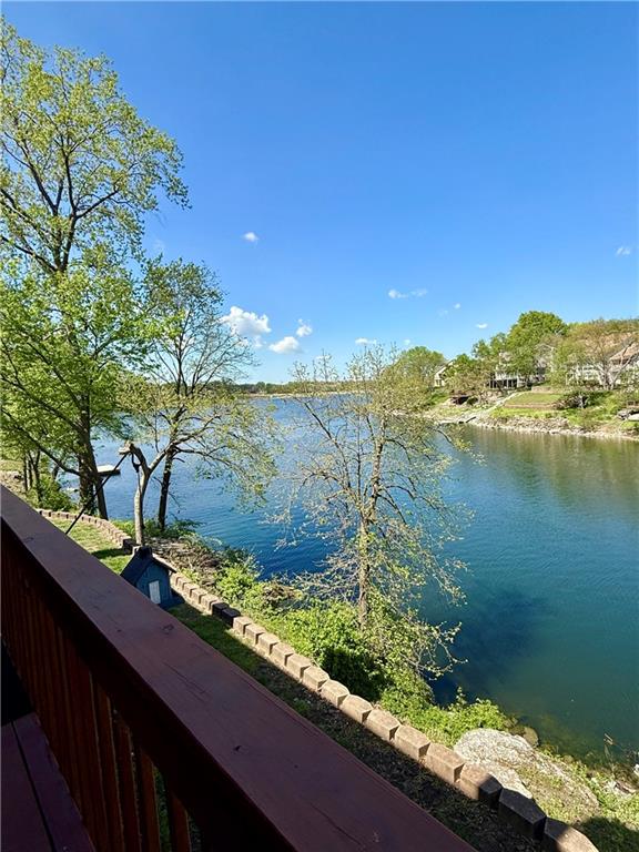 Welcome to lake life, elevated. This MAINTENANCE FREE townhome sits directly on the water, serving up stunning views, natural light, and effortless indoor-outdoor living at every turn. Slide open one of four glass doors and step onto your deck to soak in the lake; morning coffee and sunset unwinding just hit different here.The finished walkout lower level offers a private retreat complete with its own bedroom, full bath, kitchenette, and dedicated laundry that's perfect for guests, extended stays, or a little extra space to breathe. With a covered lakeside patio just steps away, it’s like having your own peaceful escape right at home.Fresh updates, stylish finishes, and zero maintenance worries mean you get to focus on what matters most… enjoying the view.