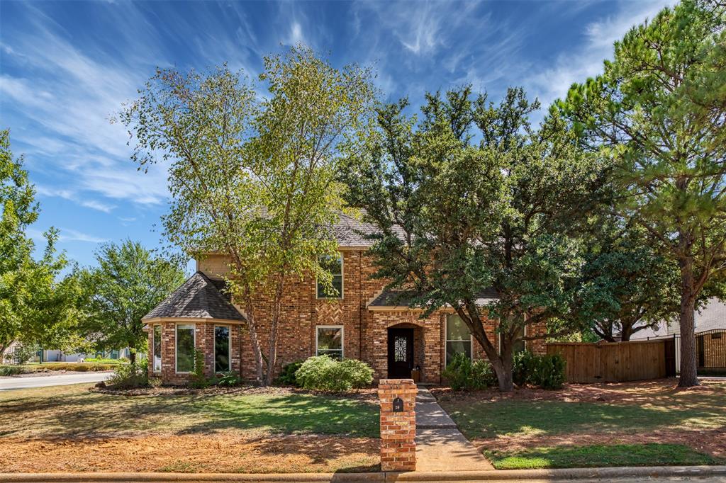 Beautiful home with mature shade trees on an oversized corner lot in Trophy Club. This corner-lot traditional rancher-style home offers a perfect blend of comfort and functionality. As you enter, you'll be greeted by spacious rooms with dark engineered wood floors throughout the main living area. The front dining room overlooks the beautiful landscape and features raised ceilings. The large kitchen offers double ovens and ample cabinetry for storage. The breakfast nook boasts large windows, allowing plenty of natural light to accentuate the granite countertops and charming cabinetry. The primary bedroom features a generous layout with an ensuite bathroom equipped with double vanities and a soaking tub, flanked by a large walk-in closet. Three additional bedrooms upstairs provide space for family members, guests or the flexibility to create a home office. A game room or hobby room with half bath off the main living area offers the perfect space for holidays, game day or a kids' play area. Step outside to the backyard, where you'll discover a private sanctuary that beckons you to unwind and enjoy the outdoors. Don't miss this opportunity to be in a prime location close to Trophy Club Golf, parks, Northwest ISD schools, shopping centers, and other amenities. Commuting is a breeze with convenient access to major highways and public transportation options. Sellers are offering a 2% buydown concession with an acceptable offer!