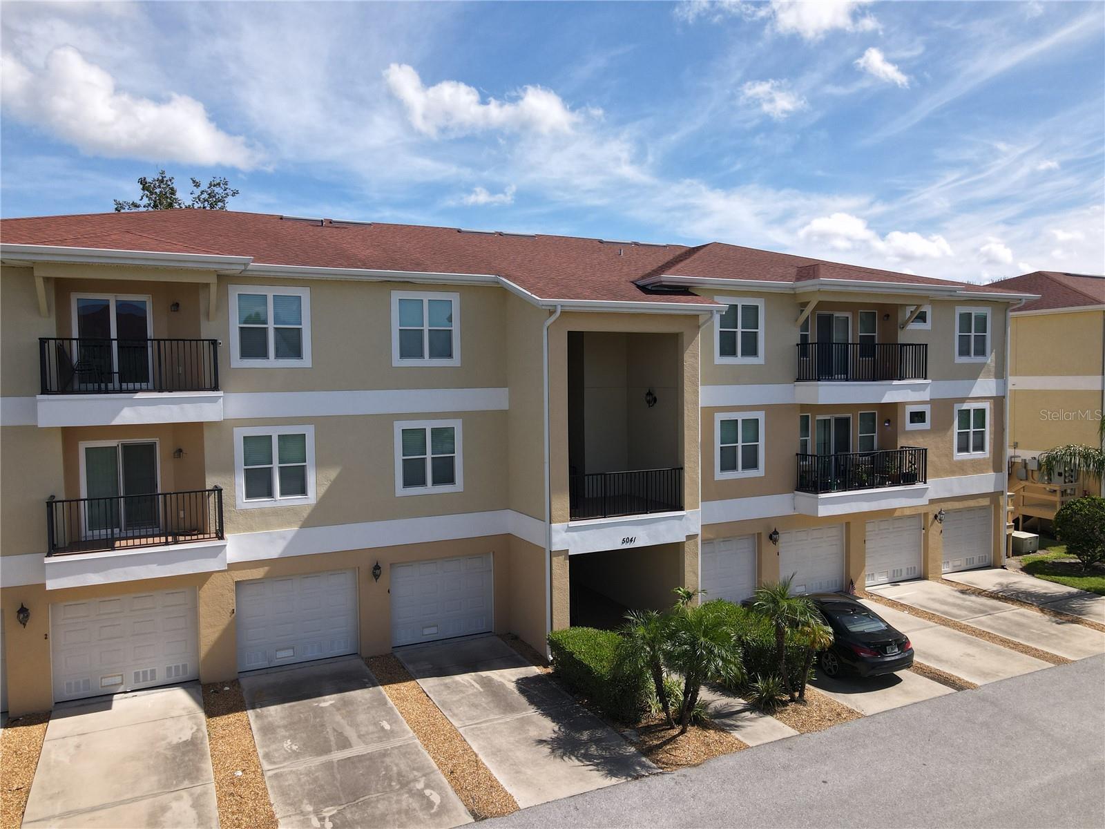 Enjoy the best of Florida living in this beautifully appointed 2-bedroom, 2-bath condo in Regency Palms, just minutes from Downtown New Port Richey and the Gulf! This spacious 1,060-square-foot home features an open, split-bedroom floor plan with soaring ceilings and a bright living area that flows seamlessly into the kitchen and dining space. The kitchen offers 42-inch cabinetry, granite countertops, stainless steel appliances, a breakfast bar and pantry. Step outside onto your private balcony overlooking the peaceful wooded surroundings—the perfect spot for morning coffee or an evening drink. The primary suite features a generous walk-in closet and private bath with granite and a travertine shower, while the guest bedroom and full bath provide plenty of privacy for visitors. A one-car attached garage plus additional bonus/storage space offers flexibility rarely found in condo living. Regency Palms residents enjoy community amenities including a pool and spa, dog park, grilling area and more. For an additional annual membership fee of approximately $200, owners may also enjoy access to the private Gulf Harbors Beach Club, where sunsets on the Gulf can become part of your everyday Florida lifestyle. And when you're ready for dinner or a night out, Downtown New Port Richey's restaurants, breweries and local favorites like SteamWorks Pub are just minutes away. Low-maintenance living, private beach access and a thriving downtown—all waiting for you!