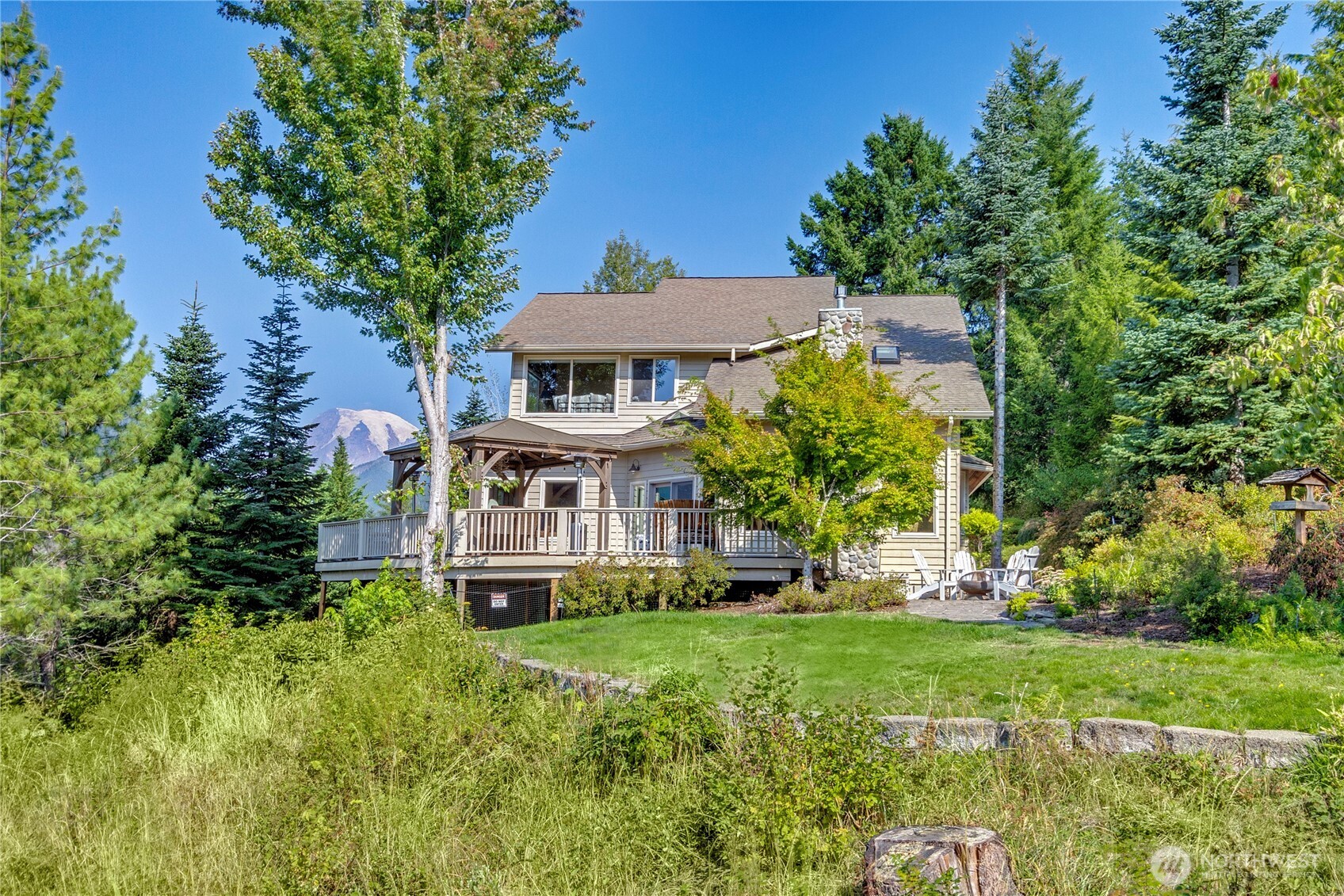 3-bed/3 bath home in gated neighborhood. Detached ADU with 1 bed/1 bath, cedar sauna. Garage/storage below. Stunning views of Mt Rainier & Cowlitz Valley/Tatoosh Range. This property is less than a mile from downtown Packwood & has easy HWY 12 access. 25 minutes to Mt Rainier Nat Park/White Pass Ski Resort. 2.5 hours to SEA & PDX. Open concept living space with river rock fireplace. Fully equipped kitchen, featuring ILVE gas range, double ovens, granite counters/maple cabinets. Expansive outdoor deck space. New hot tub & gazebo. The main home and ADU are both currently successful vacation rentals. Guests love the mountain views and relaxing sauna! Virtual tour & video available. Year-round adventure basecamp for hiking, skiing & more.