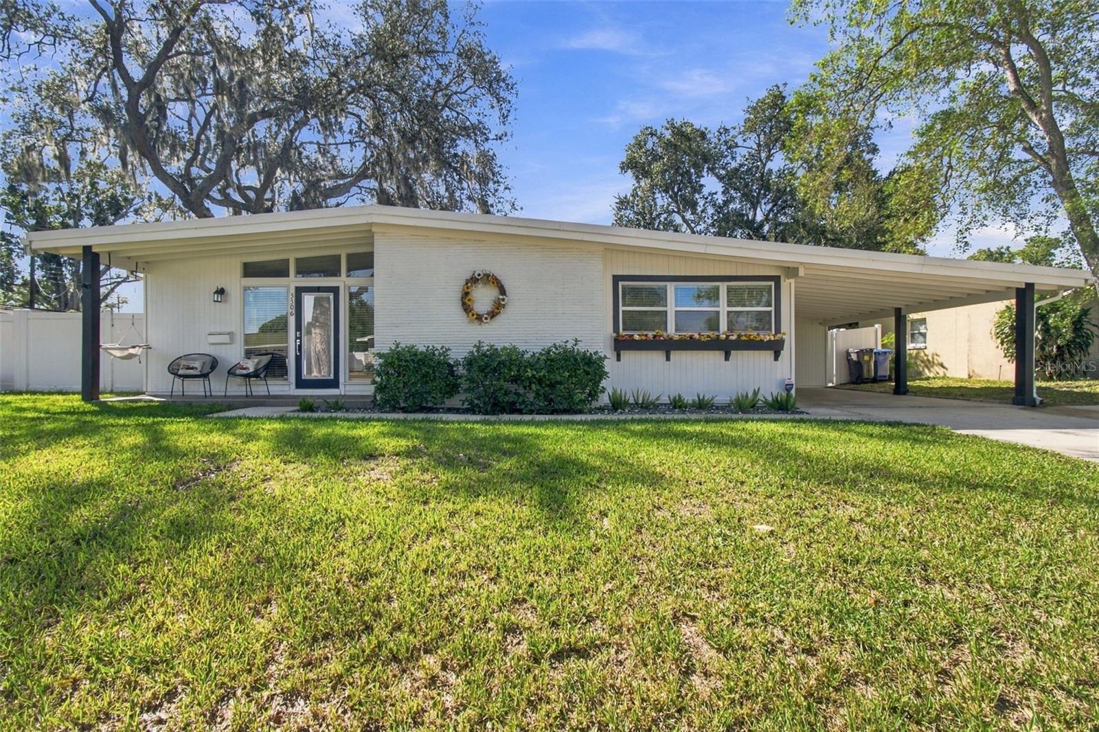 This thoughtfully updated mid-century modern-style home is set on a generous-sized lot in Original Carrollwood. An efficient, versatile floor plan offers 3 bedrooms, 2 bathrooms, and multiple spaces to gather and unwind, including a welcoming living room with large windows that invite natural light throughout, a dining area just off the kitchen, a separate family room, and a dedicated office with French doors. At the heart of the home is the kitchen, completely renovated in 2022, which features quartz countertops, designer backsplash, new cabinetry, and stainless steel appliances. Durable wood-look tile flows throughout the main living spaces, while cozy carpet adds warmth to the bedrooms. Block construction, a metal roof, and a Flood Zone X location provide added peace of mind. Outside, a spacious, fully fenced backyard with a brick-paver patio creates the perfect setting for entertaining, play, pets, or simply enjoying the Florida sunshine. Beyond the home, the Original Carrollwood lifestyle is truly something special. Residents enjoy private access to Lake Carroll via White Sands Beach and the community boat ramp, along with neighborhood parks, playgrounds, tennis courts, and a dog park all accessible only to residents. More than its amenities, Original Carrollwood is known for a genuine sense of community and generations of beloved traditions from the Fourth of July ski show and cookout at White Sands Beach to holiday parades, Christmas Eve luminaries, New Year’s Eve fireworks, and neighborhood events throughout the year. It is also centrally located to all of the Greater Tampa Bay area including Downtown Tampa, and only a 15 minute drive to Tampa International Airport, International Plaza, Raymond James Stadium, the new home of the Rays Stadium coming soon, and so much more. With distinctive architecture, thoughtful updates, a spacious backyard, and a coveted location, this home does more than check all of your boxes—it’s an opportunity to become part of the Original Carrollwood tradition.