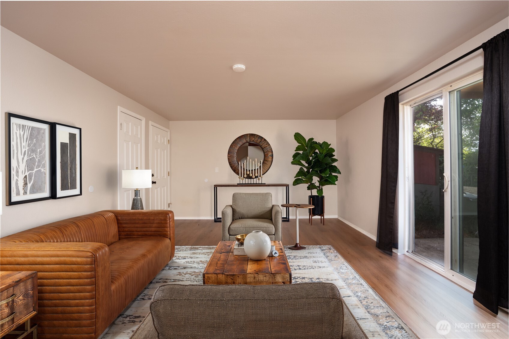 Refreshed & updated Midland condo convenient to JBLM, PLU, & uniquely positioned between Tacoma & Puyallup! Just a hop skip & a jump onto Hwy 512 can lead to Olympia, too! This location is a commuter's dream! Enter this ground floor single level condo & discover the beauty of the recent remodel! Generous sized living room has sliding door to patio and shared grassy backyard for summer relaxing with a lemonade or BBQ's with neighbors & friends! Prepping for meals will be a joy in the beautiful new kitchen...new cabinetry, counters & stainless appliances and room to enjoy your meals! Around the corner hall are 2 nicely sized bedrooms. Laundry hook ups (washer & dryer are not included in sale) in refreshed full bathroom with double sinks.  All new plumbing throughout & a new electrical panel. New roof was installed in 2025.  HOA includes water, sewer, garbage & common area maintenance. Enjoy the luxury of easy homeownership with exterior maintenance taken care of by HOA & all major systems updated.  Two parking spaces included.
