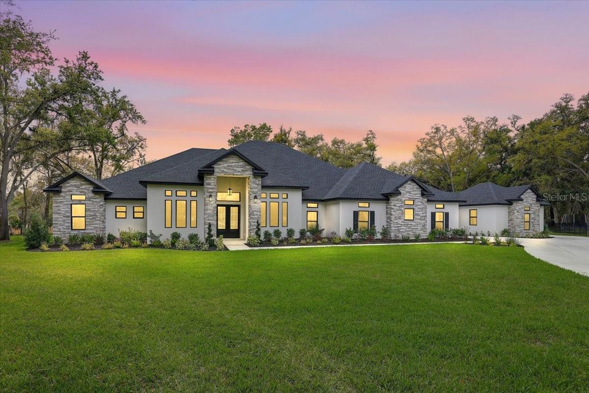 Under contract-accepting backup offers. Why wait to build? GATED COMMUNITY!!!!! HOME BUILT 2025!!!!-1.32 ACRES!!!!5359 SQ FT !!!!5 BEDROOM 4 AND HALF BATHROOMS!!!! OVERSIZED 4 CAR GARAGE!!!!POOL!!!!CUL DE SAC WITH NATURAL PRESERVE IN BACKYARD!!! This amazing home has been flawlessly designed for the pickiest of buyers. From the portico that leads to a 4 car garage and courtyard and the green space in backyard, the home takes advantage of the whole property. The open flow of the first floor layout is a remarkably livable and beautiful! This executive estate in its’ Modern styling is situated in the exclusive gated community of The Sanctuary. A striking elevation with architectural details warmly greets you and quietly says, “Welcome Home”. This newly constructed home will have you appreciate luxurious details such as wide plank wood flooring, 12 Inch baseboards, tray ceilings, well-appointed moldings, large bedrooms, large master bathroom and shower, large walk in closets etc...The open concept Family Room/Kitchen/Morning Room with its’ butler’s pantry provides the WOW factor! The TWO center-islands are the heart of the kitchen and home. Solid Wood cabinets w/crown, quartz tops, tile backsplash and stainless appliances will inspire the chef in you! Dissolving the lines between indoors and outdoors are an abundance of windows, Sliding doors allowing the sun-filled living areas to flow seamlessly to the expansive outdoor living area with pool and outdoor kitchen overlooking a large backyard. Mature landscaping and no rear neighbors provide the privacy.  The owner’s retreat is a spacious oasis. Its’ sunny sitting area features a sliding door that takes you out to its own covered lanai. The owner’s bath is luxurious and full of dramatic details. With separate vanities, a free-standing tub and a grand shower that belongs in a resort spa, you’ll never want to leave! The incredible outdoor space where you can swim, cook, dine and lounge with friends and family. Now that’s the Florida Lifestyle! The Sanctuary is close to shopping, restaurants, schools , and all that New Tampa/Wesley Chapel has to offer. SCHEDULE SHOWING TODAY!!! --