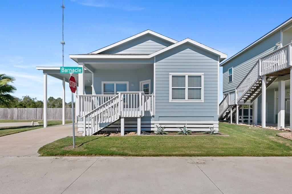 Welcome to Coral Reef Cottages! Wake up and sip your morning brew while enjoying bay breezes and beautiful sunrises from your covered porch. This adorable 2 bed/2 bath single-level home is perfectly situated near the private community pool. Downtown Rockport, shopping, and some of the area's best dining are only a short drive away with Port Aransas and Corpus Christi within 20 minutes. Grab your fishing rod and visit the fantastic public pier leading out to a great spot to drop a line or put in the boat at the Copano Harbor Marina right across the road. Built in 2015, the home features newly installed floors, spacious kitchen with granite counters, eating bar, and open concept to the large living space. The raised ceilings throughout are a refreshing touch and provide lots of room to hang your favorite local treasures. Bring the boat and park it under the covered attached carport. This sunkissed cottage is perfect for a weekend or full-time living!  STR allowed.