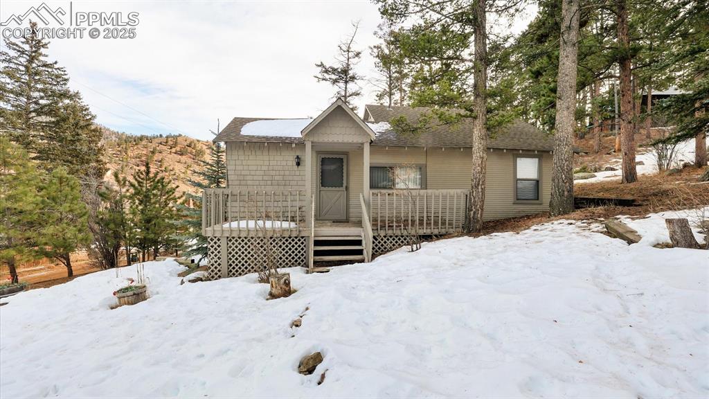 Investor's Special! Three Adjacent Properties Sold Together! Discover the potential of this unique property in Green Mountain Falls! Nestled on a picturesque 0.73 -acre treed lot, this investment opportunity features a 2BR, 1BA main-level cabin plus two additional cabins. With breathtaking mountain views and endless possibilities, this property is ideal for creating the perfect mountain retreat. The main cabin boasts a covered porch, vaulted Great Room with a beamed ceiling, and neutral finishes throughout. The Primary Bedroom includes a lighted ceiling fan and ample closet space, while the secondary bedroom has wood paneled walls and offers versatility as an office or guest room. The full bathroom and functional kitchen with dining space and essential appliances such as a gas range oven, vent hood, and refrigerator, make this a cozy starting point. There is a laundry closet with stackable washer and dryer that stays. Outdoor amenities include a backyard patio for outdoor dining and relaxation, an outdoor storage closet for tools and toys, and off-street parking. The property requires a new septic system with potential easements necessary. No HOA restrictions. Its serene mountain setting, proximity to Manitou Springs (5 minutes), Woodland Park, and downtown Colorado Springs make it a prime location for weekend getaways or full-time living. Bring your vision, creativity, and some TLC to transform this property into a remarkable investment or dream mountain escape!