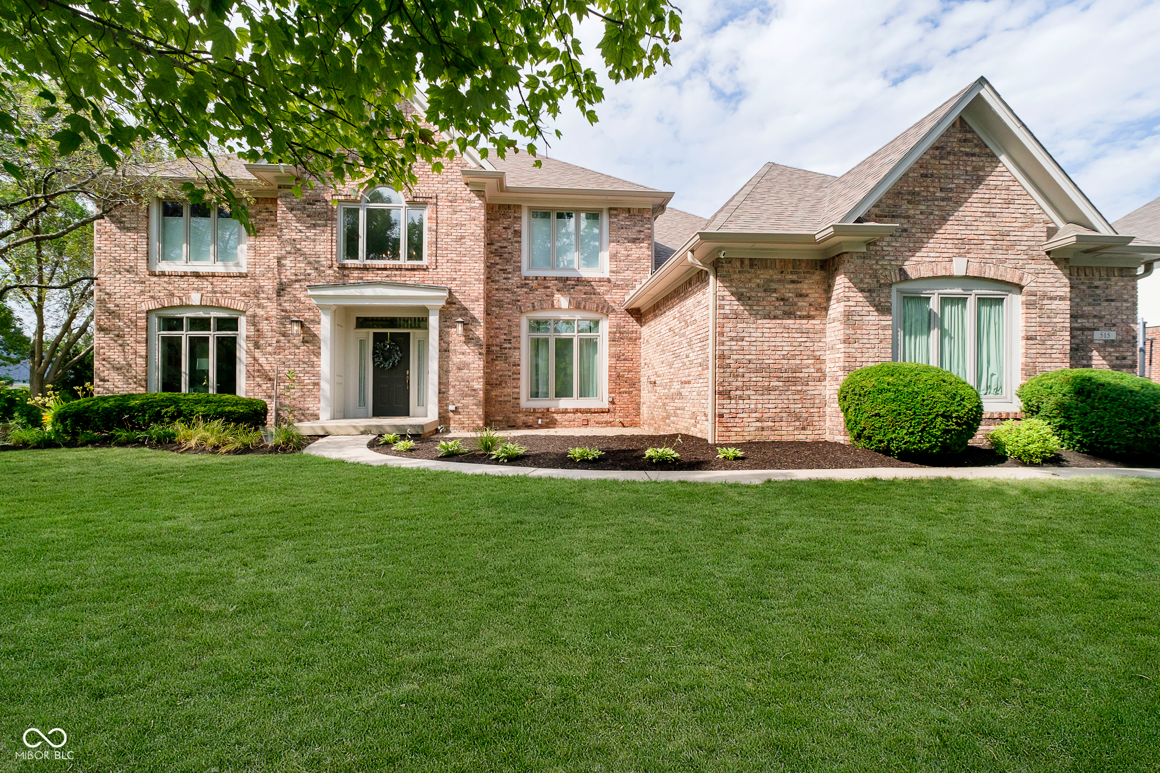 Welcome to this beautifully updated two-story home in sought-after Ponds West. From the moment you step inside the soaring two-story entry with new hardwood floors on the main level, you'll notice the light-filled, open layout and attention to detail throughout.  The main level features a bright library and dining room, a spacious office with a wall of built-ins, and stunning new hardwood flooring. The completely remodeled kitchen is a showstopper, featuring top-of-the-line solid wood soft-close cabinetry, quartz counters, a massive 72" island, double oven, and sleek low-profile OTR microwave. The family room is anchored by a cozy fireplace with custom built-ins, while the screened porch and deck invite you to enjoy the natural setting. A fabulous new mudroom with a huge walk-in pantry sits conveniently next to the main-level full bath-an ideal setup if a fifth sleeping area is ever desired. Upstairs, the bedrooms are generous in size, including one with extensive built-ins, perfect for a highly functional home office. The finished lower level offers a media room, kitchenette, full bath, and an additional guest/den space. Recent updates include a new roof, gutters, siding, rear windows, high-end mechanicals, new moldings, fresh paint throughout, and updated interior and exterior light fixtures. With its thoughtful updates, oversized pantry and mudroom, and room for everyone-all on a quiet interior lot in Ponds West-this home is truly move-in ready. Neighborhood amenities include a pool with lifeguard, tennis and basketball courts, and ponds perfect for fishing. The community is also close to great shopping, dining, and Carmel's walking and biking trails.