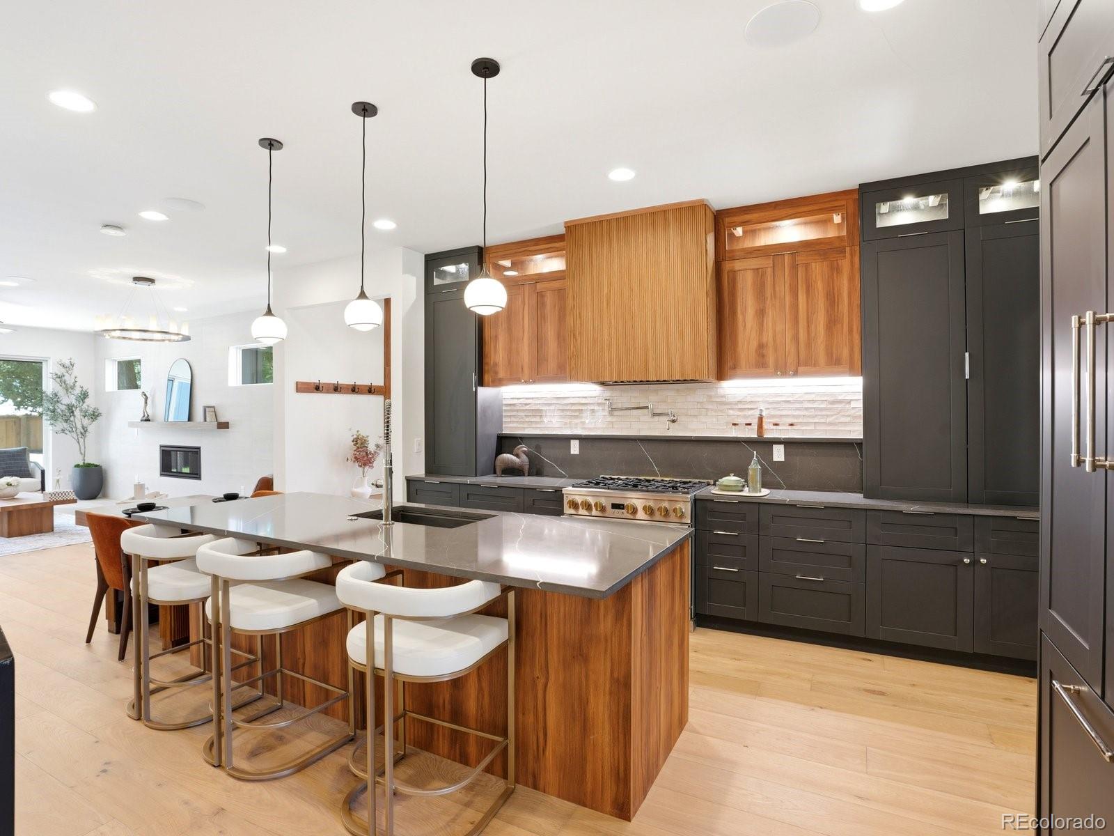 Just 4 blocks from Washington Park, this 2026 new-construction residence offers nearly 4,000 sq ft with 5 bedrooms, 4.5 baths, a private main-floor study/dining, loft, rooftop deck, large yard, and extra-height 2-car garage + 1 parking pad. Thoughtfully designed to live like a luxury single-family home, it features a wide, tall, light-filled floor plan with excellent separation and privacy across all levels. Stair placement on both sides creates a more open, functional flow than a typical residence.Main level features 9.5' ceilings, wide great room with architectural fireplace, chef’s kitchen with 9.5' quartz island, pot filler, professional range, paneled appliances, custom cabinetry, designer tile, dedicated mudroom, private study, and wide-plank hardwood throughout, including the lower level.Lower level features 10' ceilings, wet bar with dining, fireplace, spacious family/theater room, built-in speakers for 7.1 surround sound, setup for a 135-inch projector screen on the large TV wall, ensuite bedroom with wardrobe, dedicated laundry, and private exterior entrance.Primary retreat includes private balcony, custom built-in dressing closet, and spa 5-piece bath with LED-lit makeup mirrors. Top-floor bedroom with panoramic views. Loft with wet bar opens to a large rooftop deck with views. Set on a 3,550 sq ft lot with a large yard, extra-height 2-car garage, and parking pad. Additional features include ** 2 HVAC's , 2 laundry's, ** smart-home integration, built-in audio, security cameras, iPad control, enhanced insulation, energy-recovery ventilation, and performance-tested construction exceeding typical new-construction expectations.Walk to WashPark, neighborhood shops and Broadway. 5 min to Cherry Creek.  *** FLEXIBILITY -  Rare private side access and exterior entry to lower level complete with bar area, dish washer and washer/dryer.  Flexible space for guests, home office or extended family ***