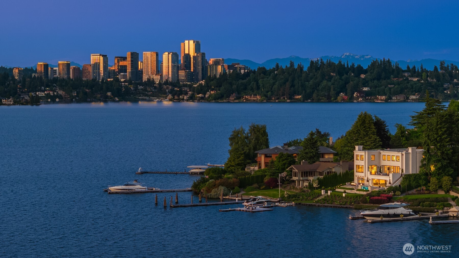 Procured Perfection of unparalleled quality, a European Modern on Mercer Island’s coveted northend. 102 ft of lowbank waterfront & gated street-to-water privacy just a short stroll to town. A collaboration of epic execution: Stuart Silk, Toth Construction & Susan Marinello Interiors. Dramatic & distinctive, every detail was curated to a level of sublime excellence. Walls of glass spill out to stone patios showcasing the sparkling Seattle skyline & bold golden sunsets. Manicured grounds with multitudes of white hydrangeas dancing at the water’s edge. 100-ft yachtsman's dream dock boasts rare entertaining platform that lowers into the water. Cutting-edge tech smart. 5 ensuite bedrooms, gym at lake level, elevator…this 2021 build has it all!