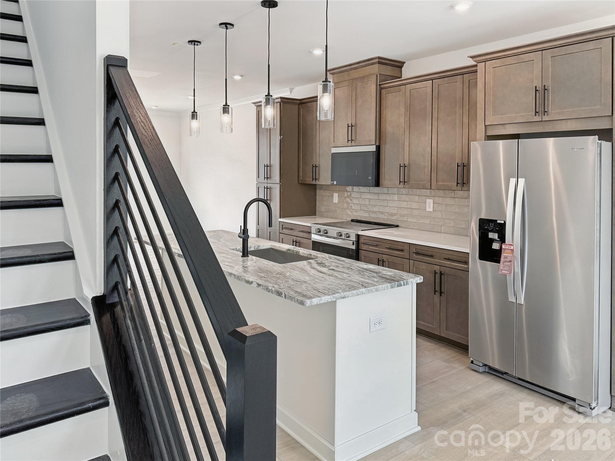 Experience modern luxury in the heart of LoSo, one of Charlotte’s fastest-growing areas. This brand-new, move-in ready Dunbrook floorplan townhome, offers 3 bedrooms, 3.5 baths, fenced in front yard and a 2-car garage—with a private en-suite bath in every bedroom, ideal for roommates or guests.Designed for seamless indoor-outdoor living, the open-concept main level extends from the Great Room to an outdoor living area, while the rooftop terrace provides an elevated space for entertaining or unwinding. The designer kitchen features quartz countertops, soft-close cabinetry, and a spacious island, complemented by hardwood stairs and luxury vinyl plank flooring throughout the main living areas and fourth-floor bedroom.Additional highlights include durable Hardie Plank siding, crown molding, zoned thermostats for enhanced comfort, and abundant natural light throughout.Located just two blocks from the LYNX Blue Line at Scaleybark Station, with quick access to South End’s dining, breweries, and Uptown.Limited-time financing incentives available—contact agent for details.