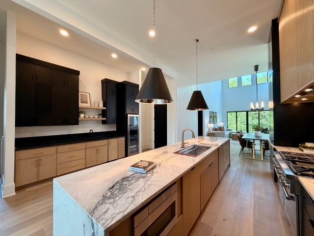 Walkable Green Hills luxury on a rare 0.5-acre deep lot—featuring an expanded chef’s kitchen, main-floor primary, and endless pool potential. Positioned just steps from the Hill Center, Green Hills Mall, and the YMCA, this masterfully redesigned contemporary estate delivers architectural distinction on one of the area's most expansive half-acre lots. Redesigned with a seamless, open-concept layout, the heart of the home centers around a showstopping chef's kitchen outfitted with custom paneling, Thermador appliances, full-slab stone backsplash with pot filler, a dedicated butler's pantry, and double beverage stations. Double-height ceilings and oversized glass flood the home with natural light while anchoring the grand main-floor living spaces. The main-level primary retreat features a spa-inspired wet room with custom tile, freestanding soaking tub, dual vanities, and a custom boutique closet. Step directly out from your suite to a private rear deck equipped with a two-sided gas fireplace—ideal for tranquil evenings or effortless indoor-outdoor dining. Flexibility reigns on the light-filled lower level, perfectly suited for a private nanny/au-pair suite, multi-generational living, high-end media room, or executive gym. Outdoors, the super-deep lot offers rare privacy and an ideal footprint for a custom pool, pool house, and private gardens. OPEN HOUSE SUNDAY, 8/16 2-4PM!