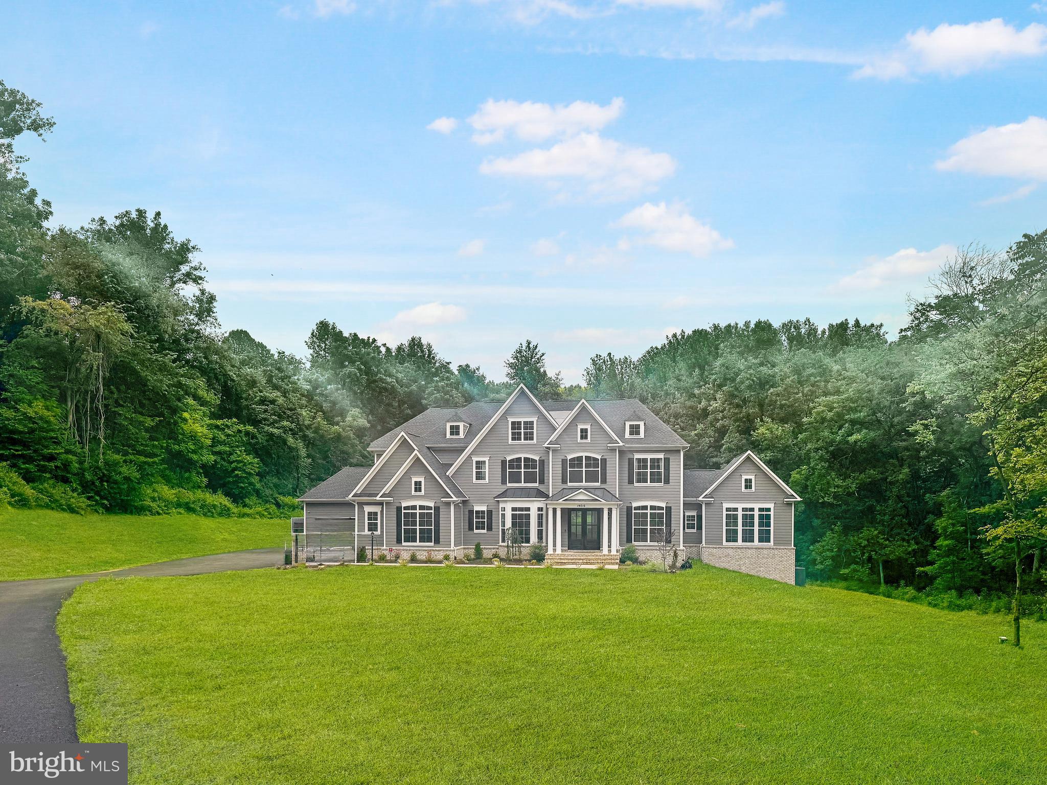 Perfectly positioned on 15 private acres within the prestigious Hunt Ridge Preserve, this exceptional Carrington Magnolia Way estate offers the rare combination of refined luxury, thoughtful design, and peaceful countryside living. Surrounded by rolling landscapes and mature woodlands, the property provides complete privacy while remaining just minutes from Western Loudoun's wineries, equestrian destinations, and historic towns.Beautifully appointed with engineered hardwood flooring, upgraded designer carpet, and elegant quartz countertops, the home blends timeless craftsmanship with sophisticated modern finishes. A gracious foyer welcomes guests into formal living and dining rooms, a private executive office, and a sun-filled morning room overlooking the surrounding landscape.At the heart of the home, the gourmet kitchen is designed for both entertaining and everyday living. An expansive center island, walk-in pantry, and abundant cabinetry flow seamlessly into the inviting family room, where a gas fireplace creates a warm gathering place for family and friends. A spacious mudroom with custom built-in cabinetry and an oversized four-car garage add exceptional functionality.Upstairs, the luxurious primary suite serves as a private retreat, complete with two walk-in closets and a spa-inspired bath. Two generously sized bedrooms feature en suite baths, while two additional bedrooms share a well-appointed Jack-and-Jill bath. An upper-level laundry room adds everyday convenience.The fully finished walk-out lower level offers exceptional flexibility with a custom bar, full bath, and expansive recreation spaces ideal for entertaining, a home theater, fitness studio, guest accommodations, or multigenerational living.Offering beautifully upgraded interiors, an exceptional floor plan, and 15 acres of remarkable privacy, this Hunt Ridge Preserve residence presents an extraordinary opportunity to experience luxury living in one of Western Loudoun County's most coveted settings.