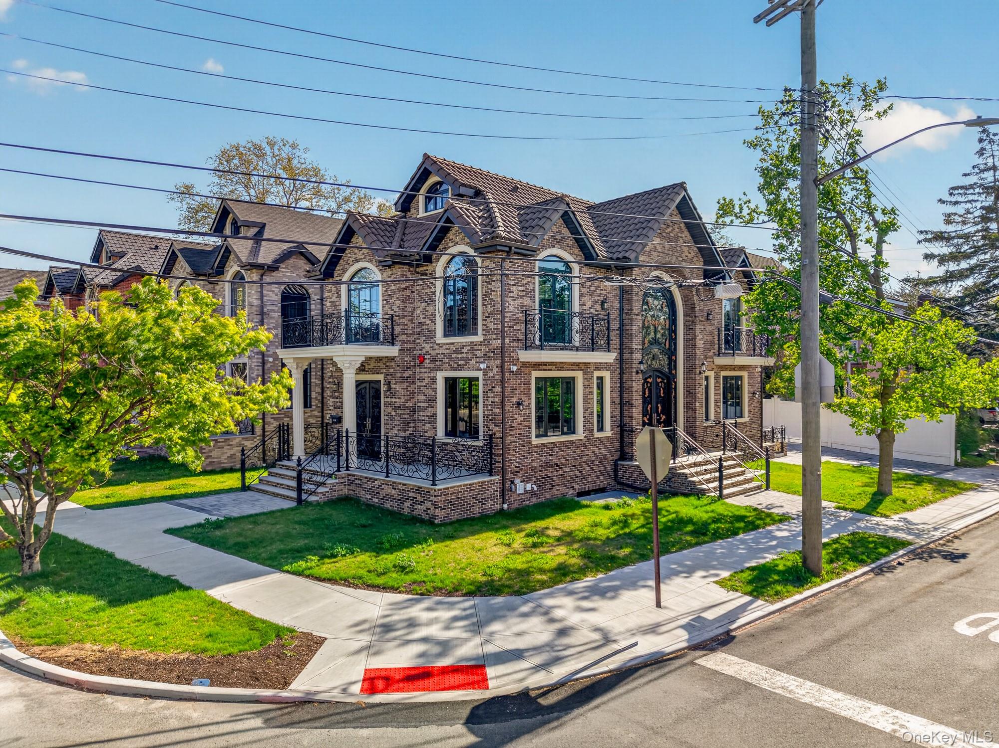 This exquisite corner-lot residence in prime Bayside features a grand double-height foyer, 4 bedrooms, and a unique dual main-entrance design. Built with high-end materials, the home is outfitted with premium brands including Bosch and TOTO, and offers central air conditioning, custom closets, and a 220V EV charging outlet. The versatile attic provides additional space, while the bright basement—with four oversized window wells and a separate entrance—offers excellent natural light and functionality.Thoughtfully designed to maximize natural light and flow, every detail enhances openness and comfort throughout. The extra-wide, long driveway accommodates 4–5 cars with ease.Ideally located within walking distance to Bell Blvd shopping, Crocheron Park, and the waterfront. Convenient access to the LIRR and major bus lines ensures an easy commute while enjoying the tranquility of suburban living.