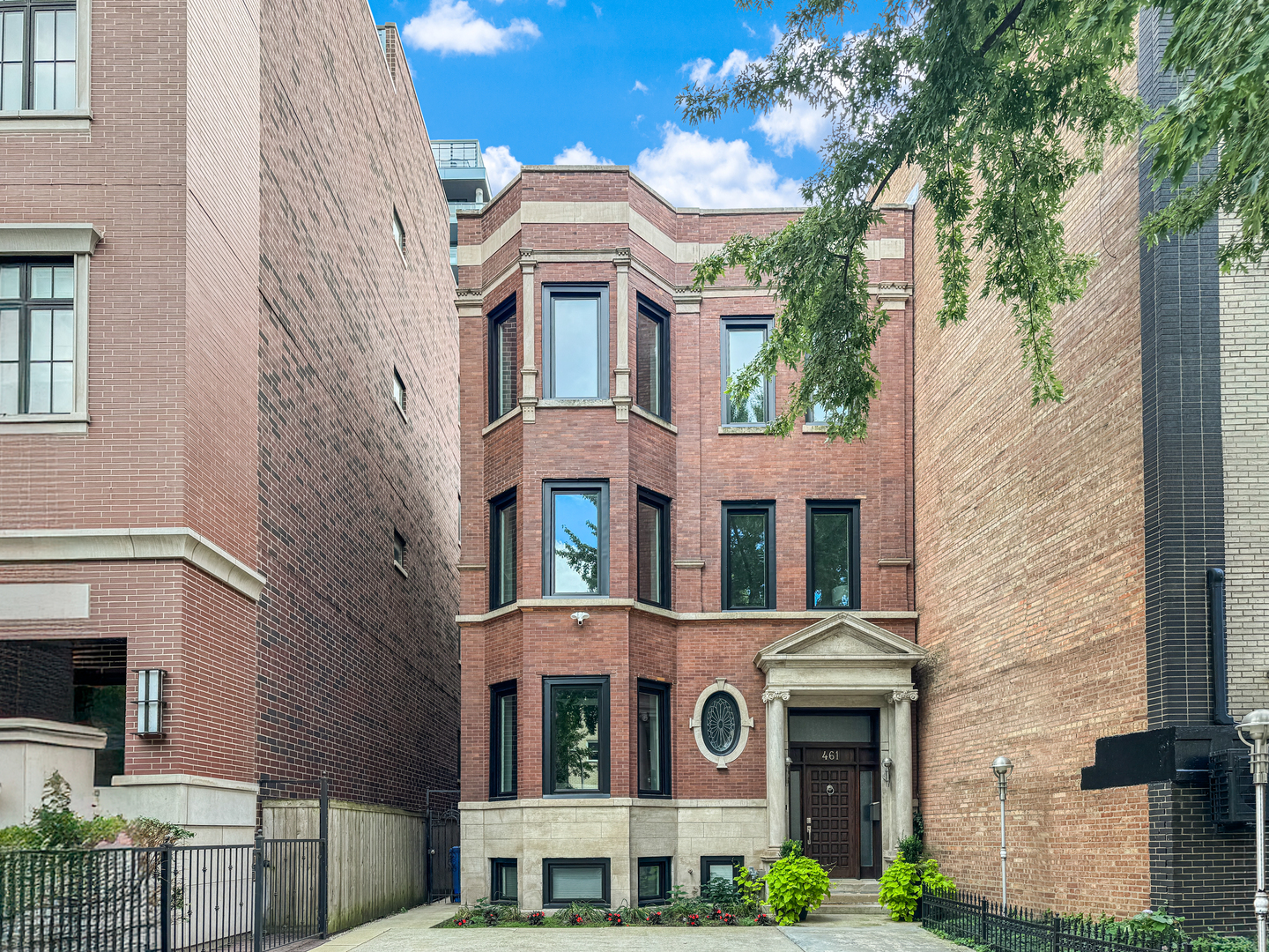 Behind a classic Chicago facade, this contemporary four-level home in East Lakeview offers spacious living and thoughtful updates throughout. Renovated in 2020, this home includes all new mechanicals, windows, designer lighting, and an elevator that connects every level, from the finished basement to the 3rd level.    The main level features a large living and dining area that flows into an open family room and a newer chef's kitchen (2020) with custom cabinetry, premium appliances, a professional-grade hood, a pantry, and a striking marble island. Ceiling heights in the kitchen reach nearly 20 feet, adding to the sense of space. With six spacious above-grade bedrooms, this home offers tremendous flexibility to accommodate a variety of needs-whether you're looking for extra space for guests, multiple home offices, a yoga room, hobby space, or simply room to grow. The primary suite includes a walk-in closet, access to a private deck, and a luxurious full bath. The finished lower level has high ceilings and flexible space for a rec room, gym, or home theater. Other features include zoned HVAC and custom closets.    Outside, enjoy an oversized, fully fenced backyard -- an uncommon find in the city -- ideal for entertaining, gardening, or play. Multiple decks provide additional outdoor living options. There is also parking for up to four cars. Located just half a block from Lake Shore Drive and Belmont Harbor, this home benefits from RM6 zoning, offering strong future development potential in one of Chicago's most desirable neighborhoods. Enjoy easy access to public transportation, including express buses to downtown, the lakefront path, Belmont Harbor, and vibrant shopping and dining along Broadway.