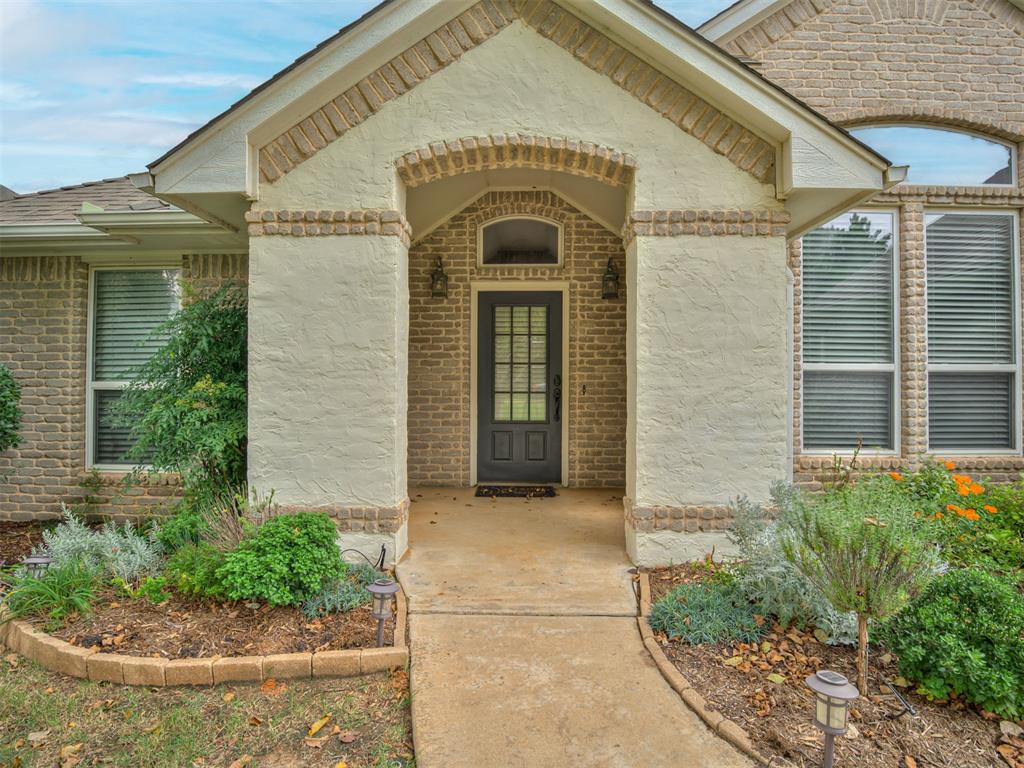 Welcome home to a thoughtfully designed space filled with character and functionality. This 3-bedroom, 2 1/2-bath home in Edmond Schools offers a perfect balance of charm and convenience.

The welcoming entryway features a cool arched barn door nook with shelves—ideal for storage or decor—and leads to a large study with tall ceilings, perfect for work, play, or quiet retreat. The kitchen is a true centerpiece with quartz countertops, a gas stove, and a brick-arched area over the cooktop that adds timeless style.

The living room shines with its unique fireplace framed by an open arched display area and flooded with natural light. The primary suite is a private retreat featuring a jetted tub, separate shower, double vanity, and a large walk-in closet for maximum storage.

Additional highlights include a 3-car garage, storm shelter, and the home’s white stucco and grey brick exterior, giving a subtle nod to Mediterranean design. A large backyard offers space to relax or play, while the neighborhood provides fantastic amenities like a pool, clubhouse, and playground—all part of an active, welcoming HOA.

This home truly combines character, comfort, and community in one inviting package. Listed by owners/agents.