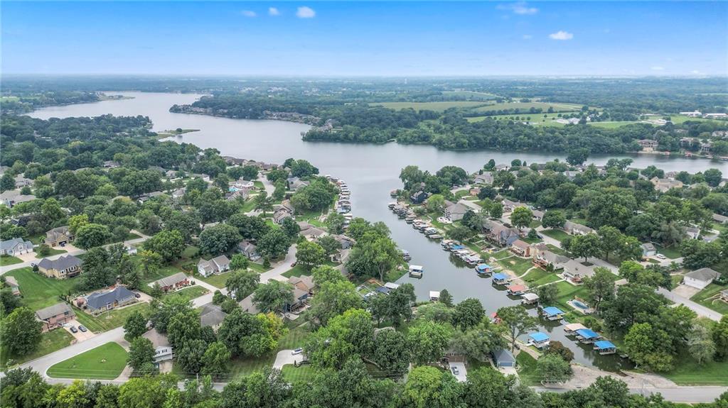 ON THE WATER - RARE OPPORTUNITY for under $1M!!  Tucked on nearly half an acre this beautifully remodeled lake front home blends timeless character with modern luxury. Inside, dark distressed engineered hardwoods flow seamlessly across the main level, guiding you through the open dining and living area to a cozy gas fireplace. Sliding glass doors open to a new Trex deck where you can soak in peaceful water views.The chef’s kitchen features premium granite countertops, thoughtfully matched throughout the home for a cohesive feel. A walk-in pantry provides space for all kitchen appliances, while the functional island offers convenient in-kitchen dining.The main-level primary suite offers tranquil water views, his-and-hers closets, and a new spa-like bath with a soaking tub and custom marble shower. Upstairs, two additional bedrooms—each with water views—share a well-appointed bathroom with a tub/shower combo.The finished walk-out lower level is perfect for relaxing or entertaining, with plush carpeting, a warm fireplace, and a wall-mounted TV ready for movie nights. Ample storage keeps everything organized, while the extra-wide garage offers room for vehicles, hobbies, and all your outdoor gear.Beyond the beautiful finishes, this home also offers peace of mind with significant improvements already completed, including a new HVAC system, new attic insulation, an extra-wide driveway, upgraded appliances that stay with the home, and a remodeled garage—making this property as solid as it is stunning.