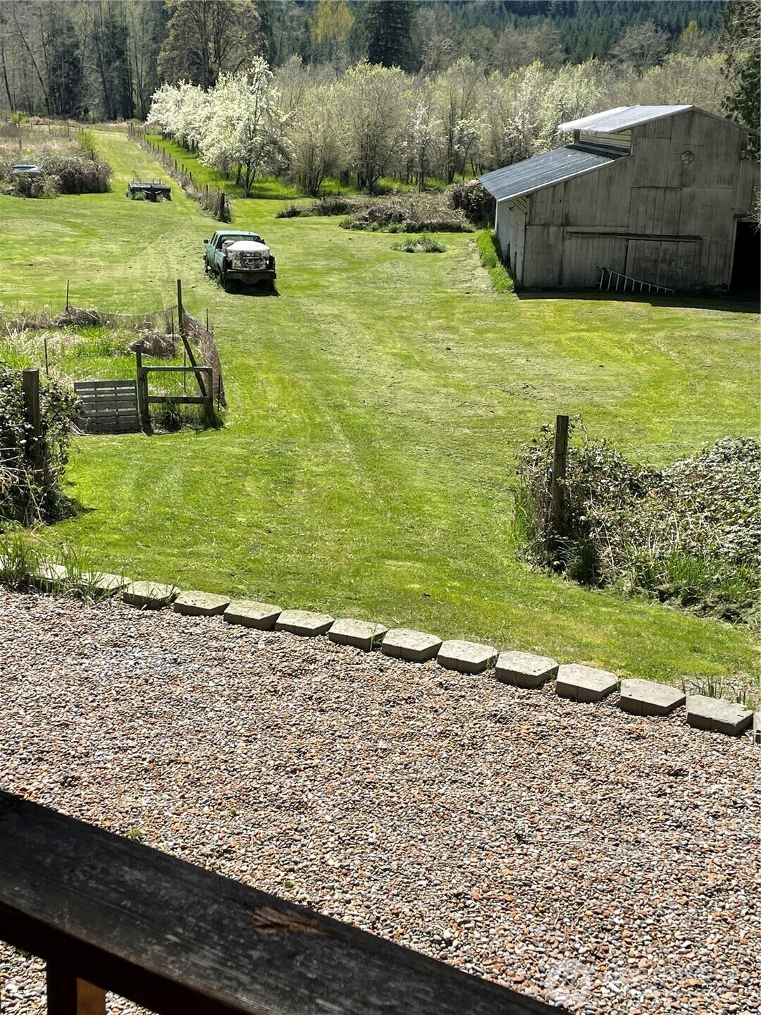 Wow, almost 20 useable acres under $650,000.......Not many properties with this much useable land out there for sale anymore, don't let it slip away! Home is 3 bedrooms, 1¾ baths, and walk-in closets. Completely renovated just off I-5 between PDX & SEA! This 1,700+ sq. ft. home features a new 40-year roof, trusses, kitchen cabinets, quartz countertops, stainless appliances, LVP flooring with carpeted bedrooms, and fresh paint throughout.  Relax on the covered front deck overlooking 19.5 beautiful acres bordered by Salmon Creek on two sides—ideal for agate hunting and fishing. Plenty of room for shop. Property includes a pond, garden space, shed barn, larger barn (needs repair), 2 car carport, and an orchard with Asian pears, apples, and plums. Private yet convenient—move-in ready with the perfect blend of peace, productivity, and self-sufficiency. With lots of rain Salmon Creek and the pond will run over the banks into the field. Water has never reached the house or the shed barn, it has ran through the large barn a few times in the past 20 years. Not required to have flood insurance. Seller stays part time in RV.