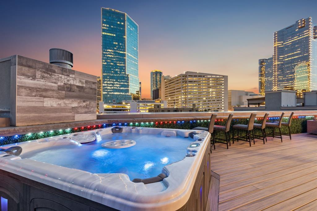 Urban Sophistication Meets Elevated Edge in the Heart of Fort Worth. 
Welcome to 409 E 7th Street, a rare opportunity in the architecturally significant Le Bijou enclave, just one block from Sundance Square, Bass Hall, and downtown Fort Worth’s best restaurants, nightlife, and culture. Corner unit designed by Schaumburg Architects and fully renovated from 2021 to 2025, this luxury townhome combines classic design, bold modern finishes, and every convenience of high-performance urban living. 
Step through double iron doors into a flexible first-floor space perfect for a gym, office, or lounge. Take the private elevator or stairs to open-concept living and dining areas with soaring ceilings, refinished hardwood floors, and oversized windows that flood the space with natural light. The chef’s kitchen is a true centerpiece, featuring quartz countertops, soft-close cabinetry, a massive island with seating, and top-of-the-line Viking appliances including a 48-in range, built-in fridge and wine coolers. Upstairs, the primary suite is your sanctuary, with a spa-inspired bath, jetted tub, walk-in shower, quartz surfaces, and a large custom closet. Throughout the home, enjoy multiple fireplaces, wood shutters, motorized shades, and Sonos-based audio, with smart home wiring and WiFi-enabled thermostats for seamless control. 
The crown jewel? A fully decked-out rooftop terrace with unmatched views of the Fort Worth skyline (video available). Think: Trex decking, Blaze grill, outdoor kitchen with dual refrigerators, prep station, ice machine, gas fireplace, natural stone surfaces with custom LED lighting, built-in heaters, two TVs, a six-person jetted hot tub, and a covered dining area. Whether it’s game night , sunsets or sunrises, this rooftop delivers. Extras? epoxy-finished 3-car garage, commercial roof, recent HVAC, Pella windows, fire protection system, and retractable wind and sun screens. This is the ultimate retreat, lock-and-leave luxury with serious urban swagger.